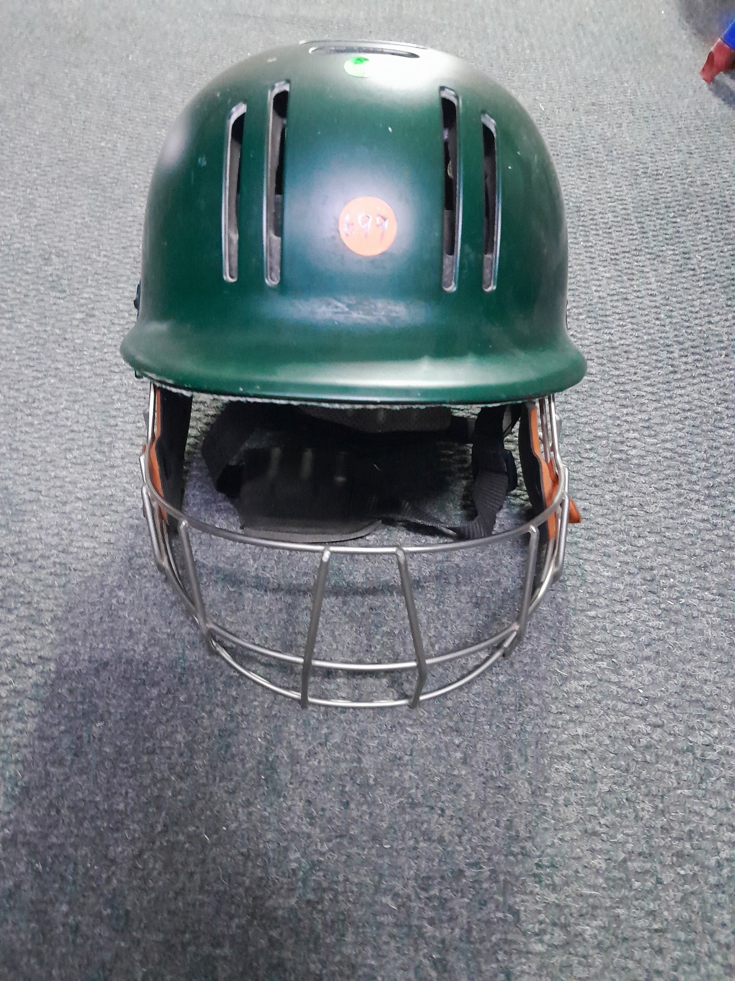 Secondhand green GM cricket helmet, offering great protection and comfort for cricket players.