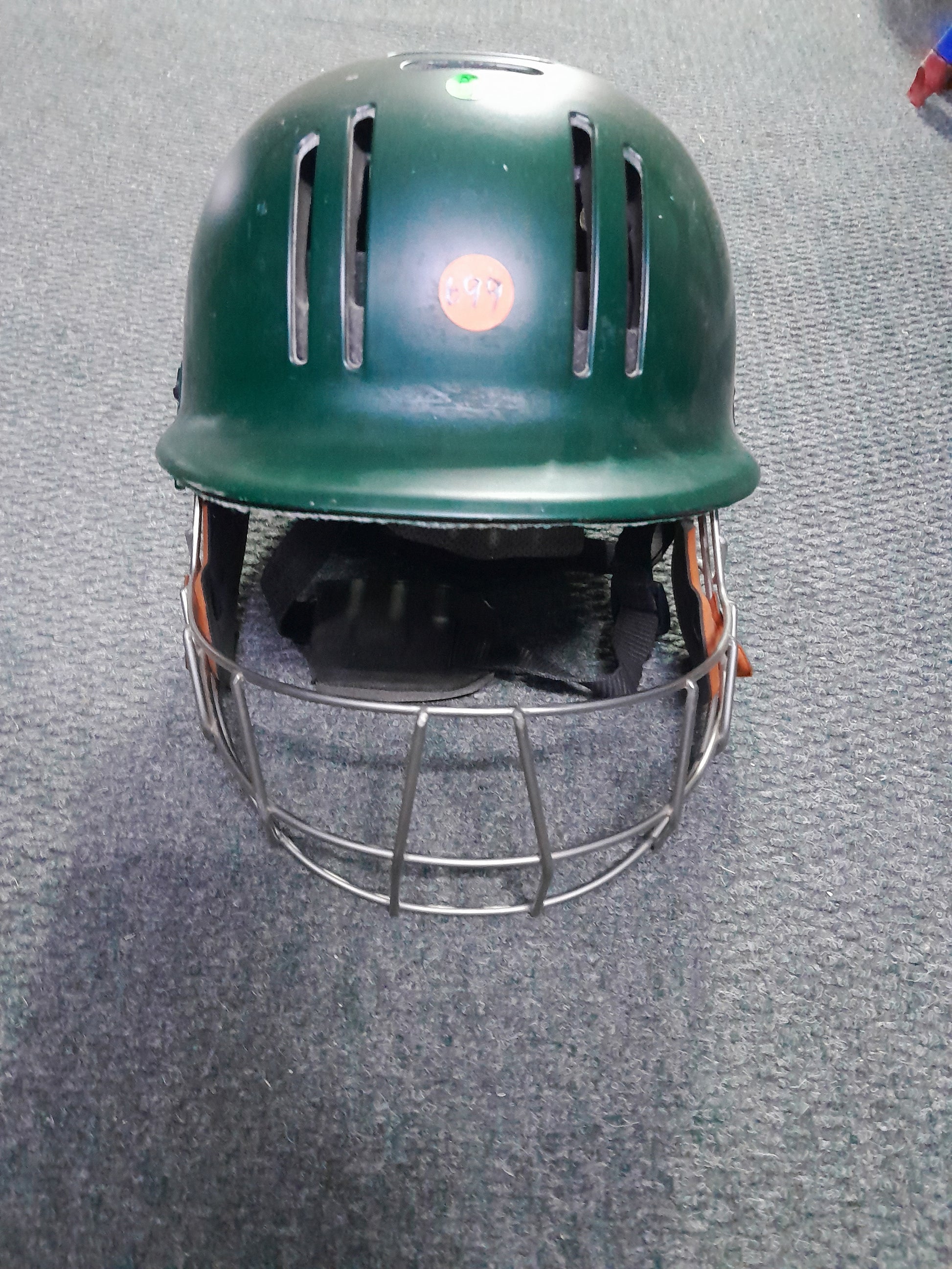 Secondhand green GM cricket helmet, offering great protection and comfort for cricket players.