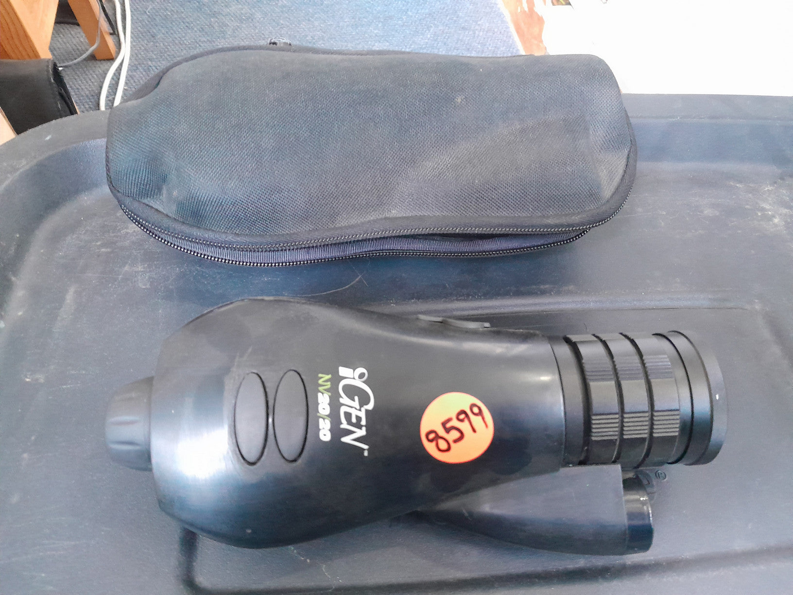 iGen 20/20 monocular on a table, showing its compact design and portability.