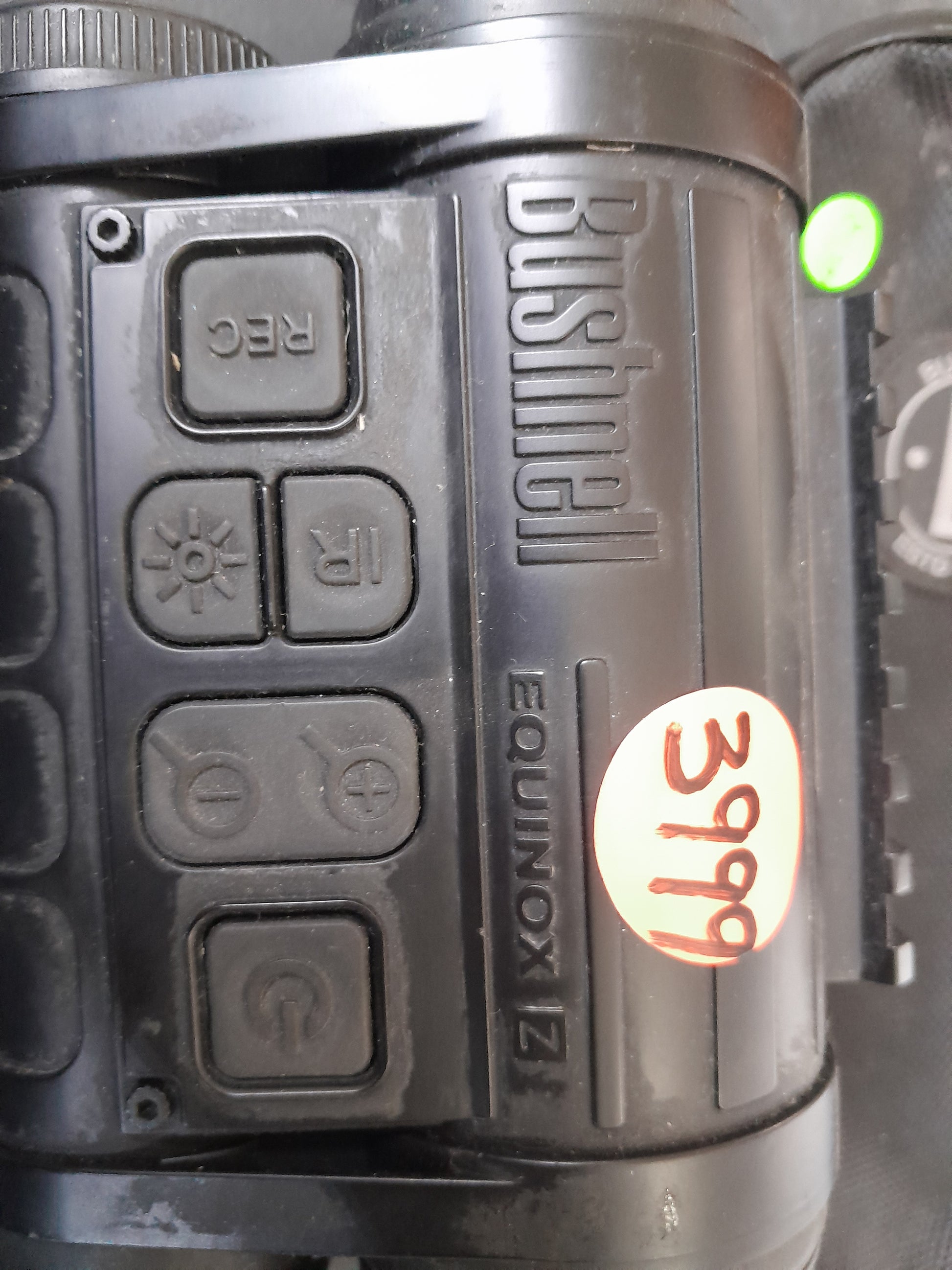 Close-up view of Bushnell Equinox Z night vision device control buttons, including REC, IR, and brightness controls. Available at Die Skatkis.