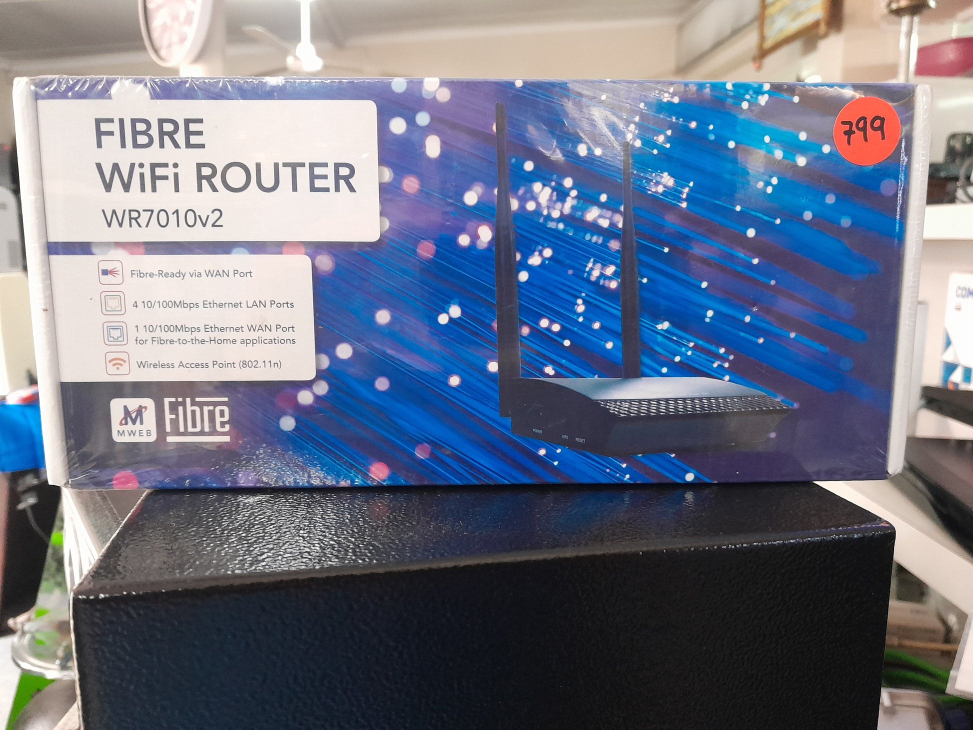 WR7010v2 Fibre Wi-Fi Router displayed in store, ideal for home internet connectivity.