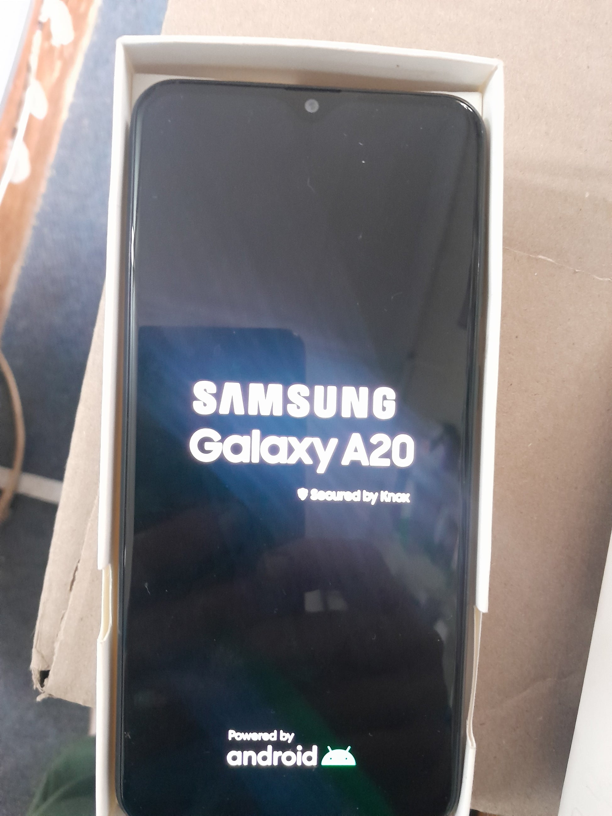 Samsung Galaxy A20 smartphone in its box, ideal for secondhand electronics shopping.