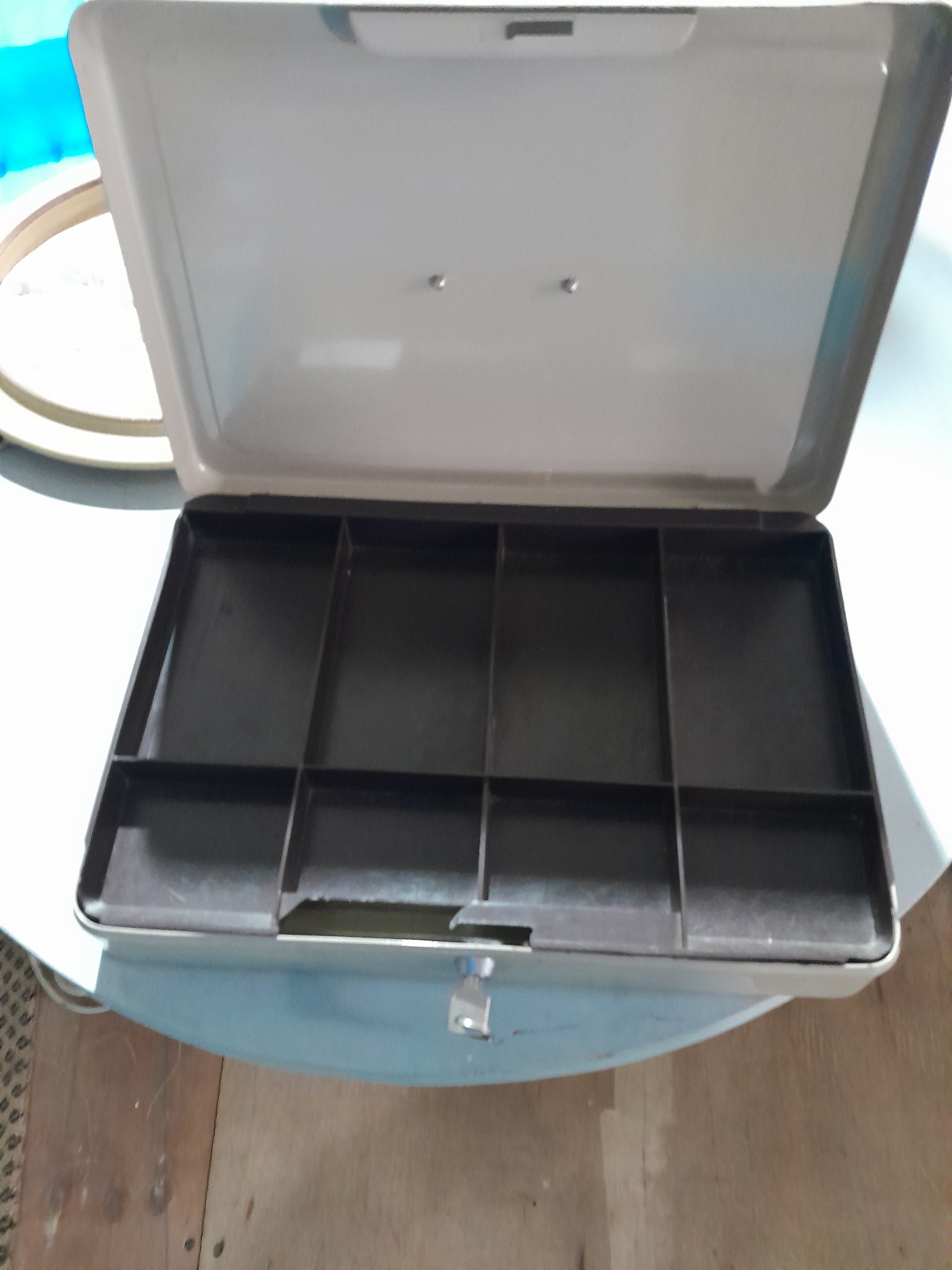 Vintage cash box with a classic design, perfect for collectors and practical use in storing cash.