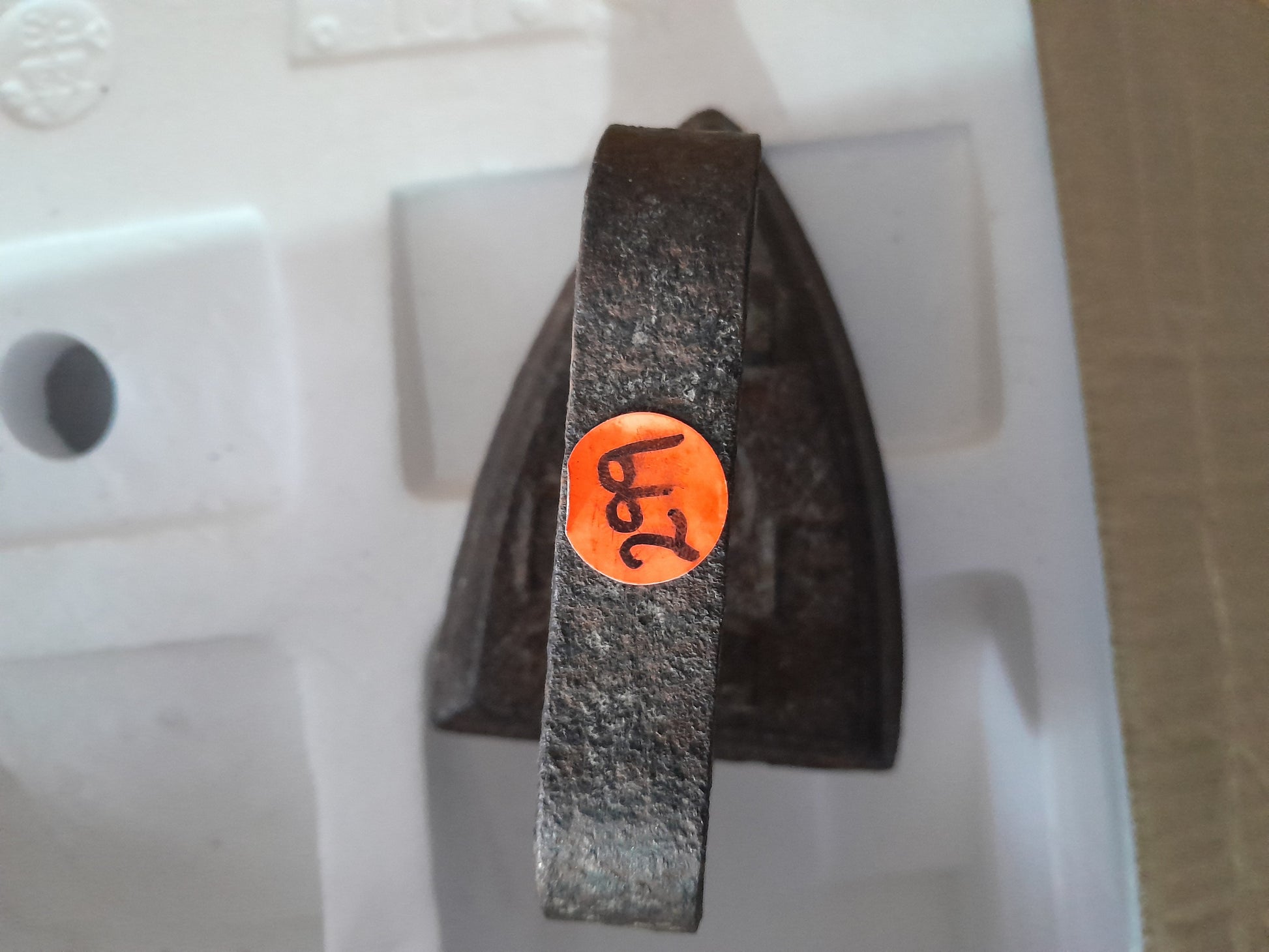 Detailed view of RF No. 4 sad iron, emphasizing its solid cast iron construction and vintage charm.