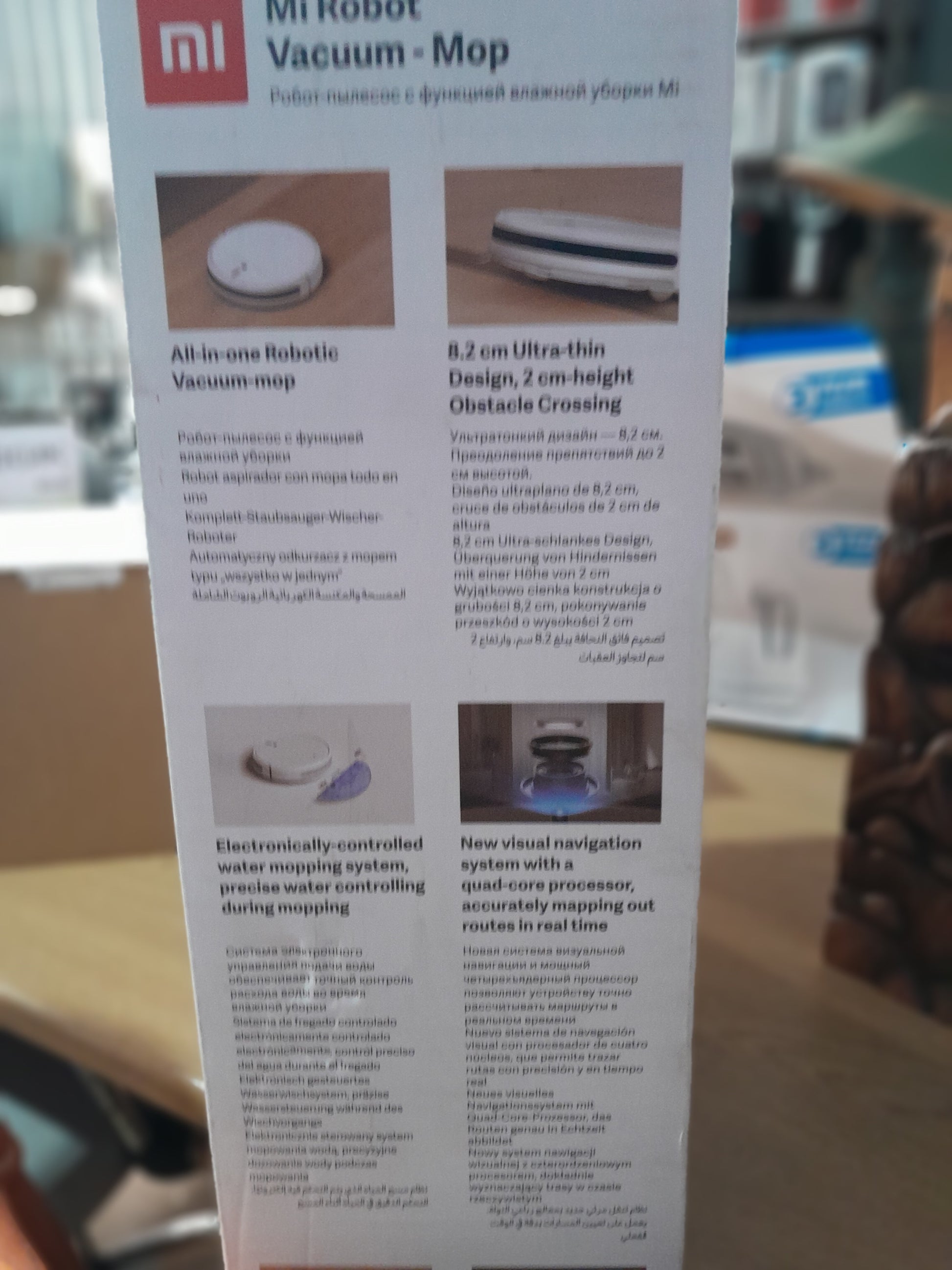Side view of Mi Robot Vacuum Mop highlighting its ultra-thin design for easy navigation under furniture.