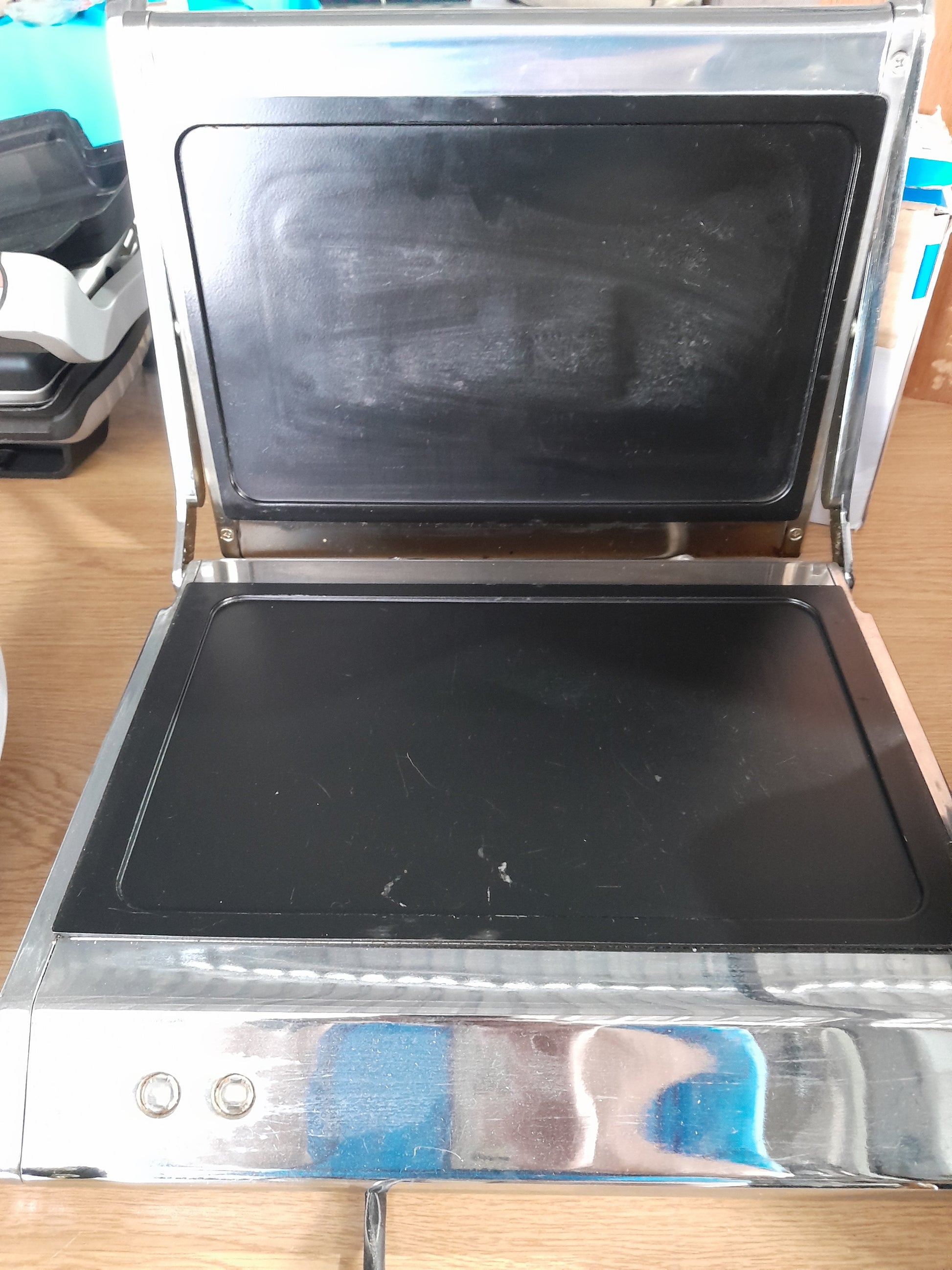 Open Russell Hobbs panini press showcasing its spacious cooking area for up to 4 slices of bread.