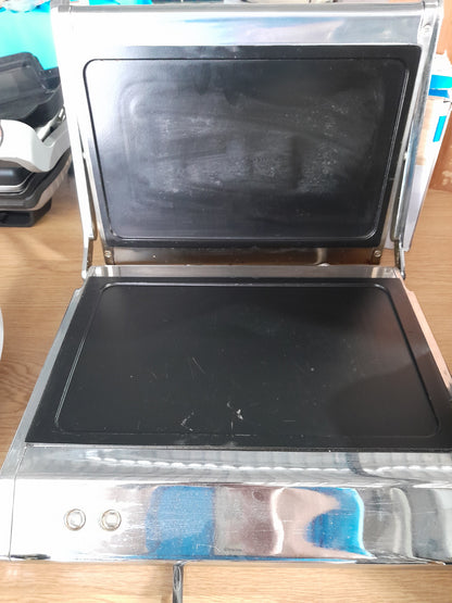 Open Russell Hobbs panini press showcasing its spacious cooking area for up to 4 slices of bread.
