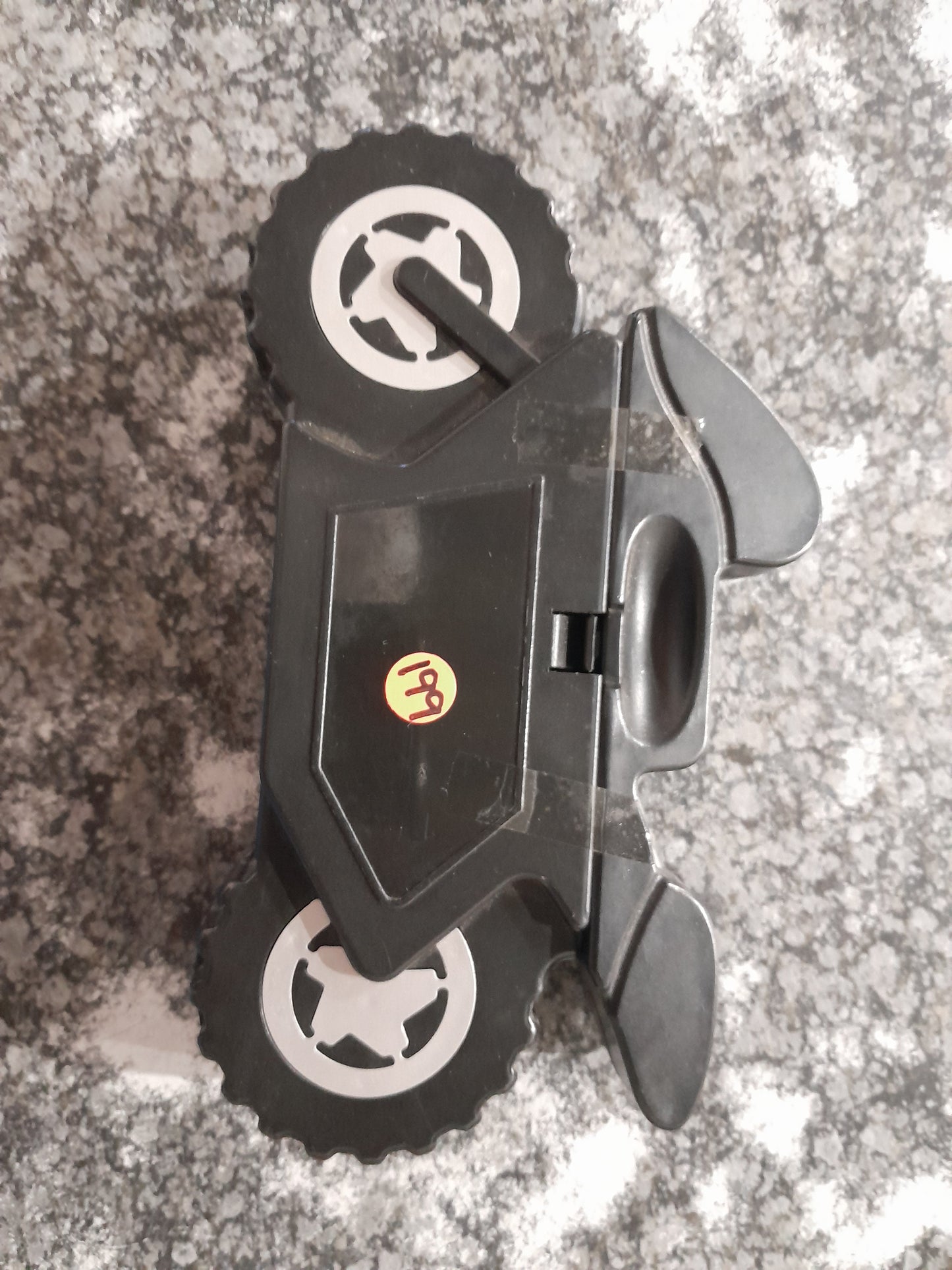Compact motorcycle-shaped toolset featuring screwdrivers and bits for basic repairs.