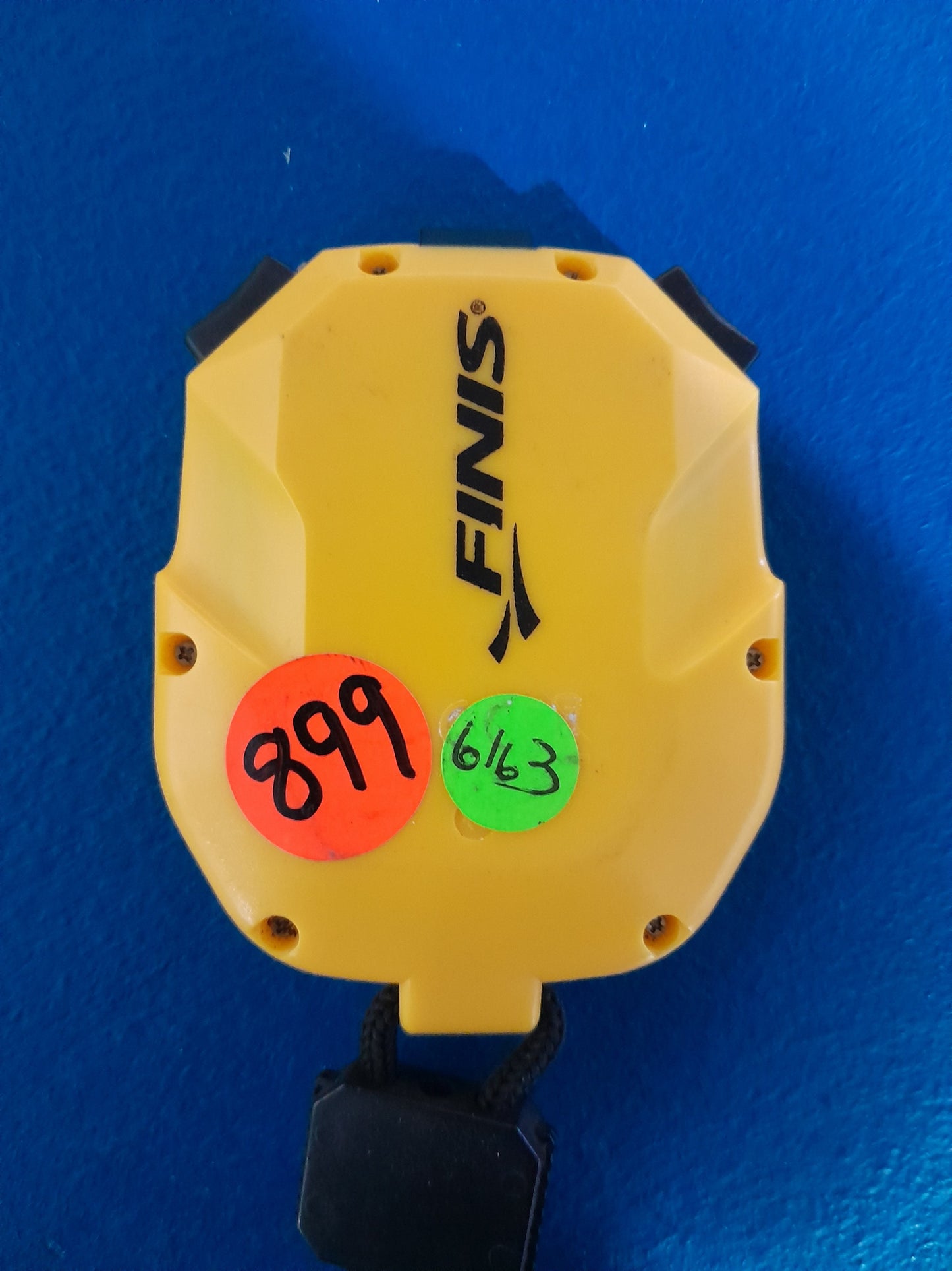 Finis 3x300m Stopwatch in yellow with price tags, suitable for secondhand sports equipment.