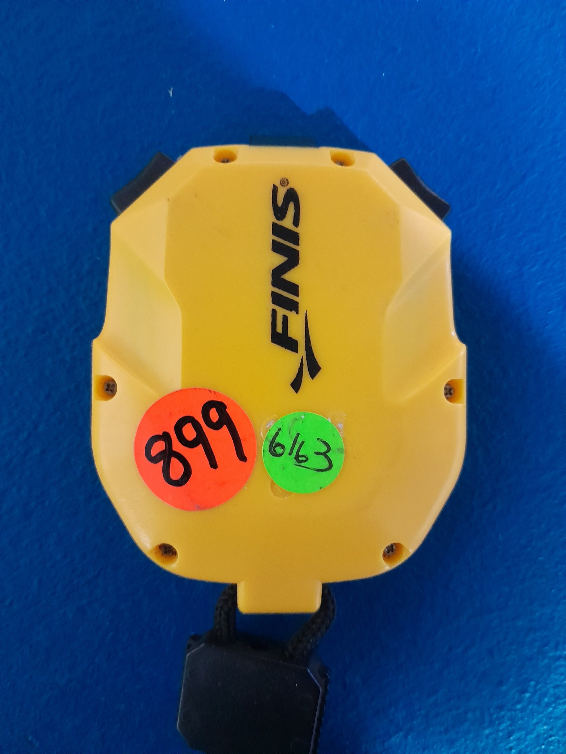 Finis 3x300m Stopwatch in yellow with price tags, suitable for secondhand sports equipment.