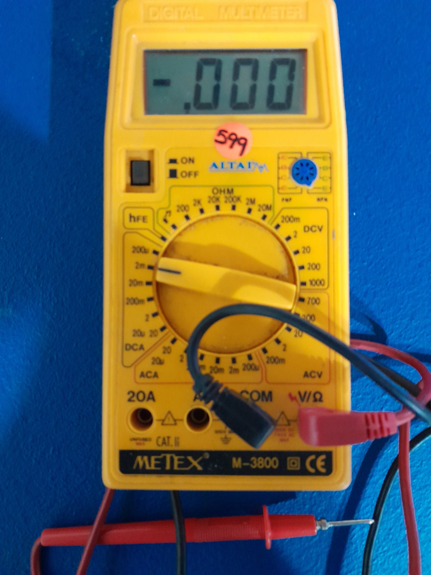 Altai Metex M-3800 multimeter with test probes connected, ideal for measuring voltage and resistance.