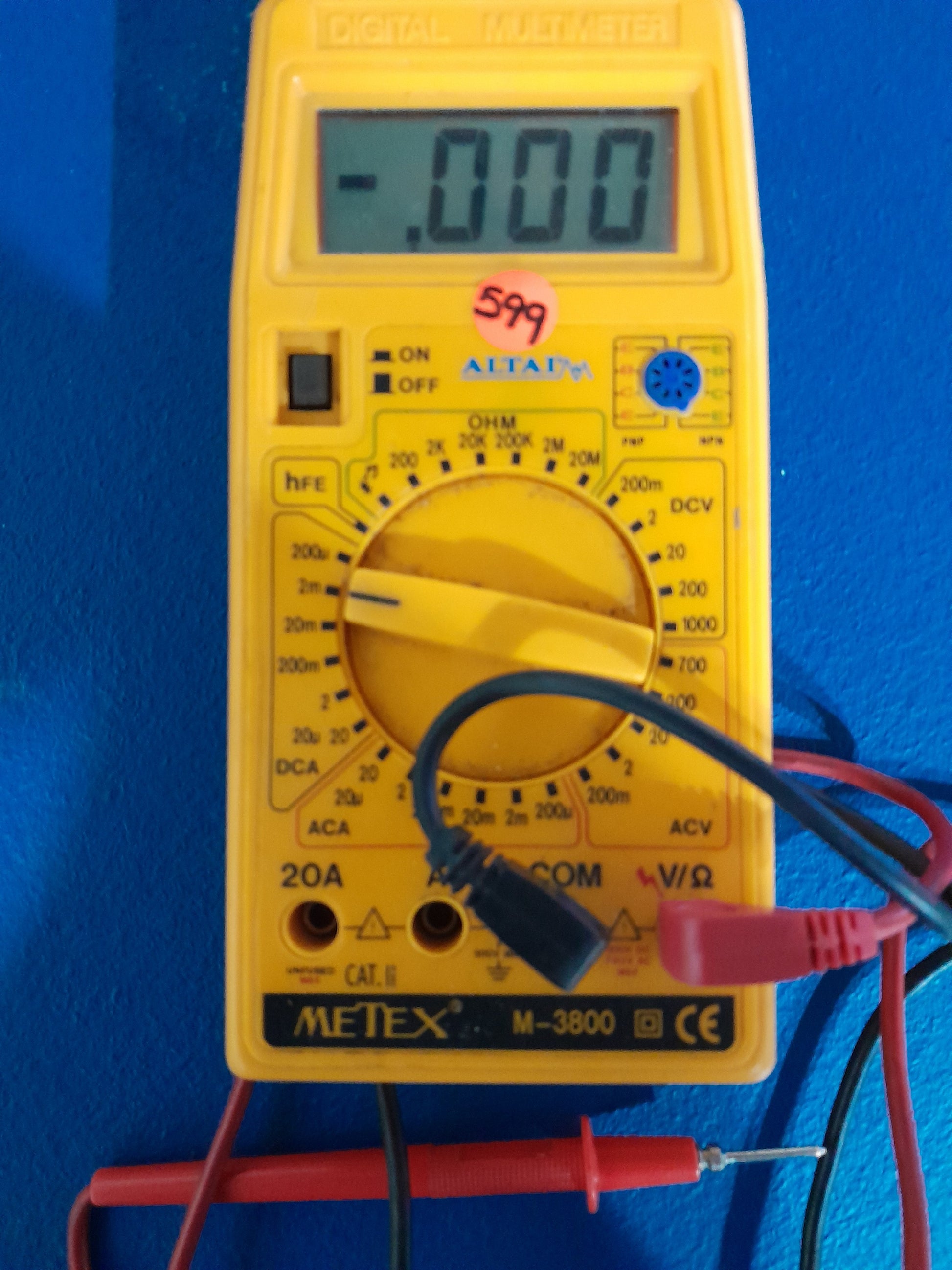 Altai Metex M-3800 multimeter with test probes connected, ideal for measuring voltage and resistance.