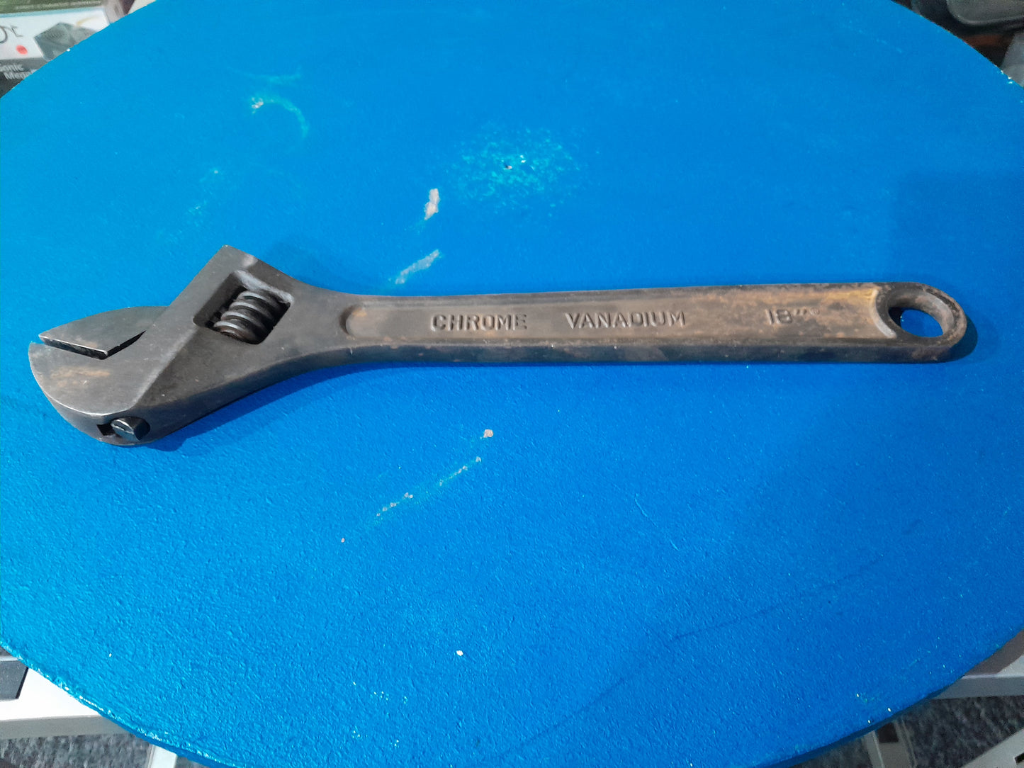 Durable Maxpower adjustable wrench on a vibrant blue background, essential for DIY projects.