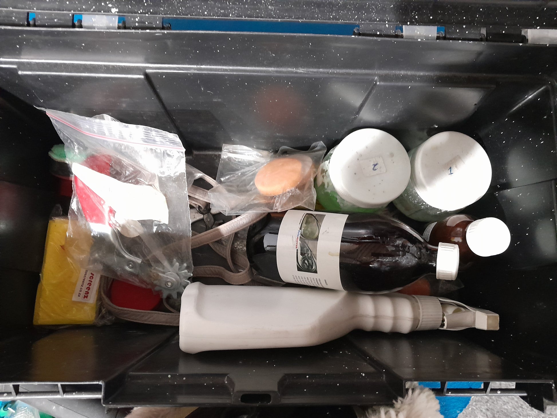 Organized MacAfric polisher kit with various cleaning and polishing materials for automotive care.