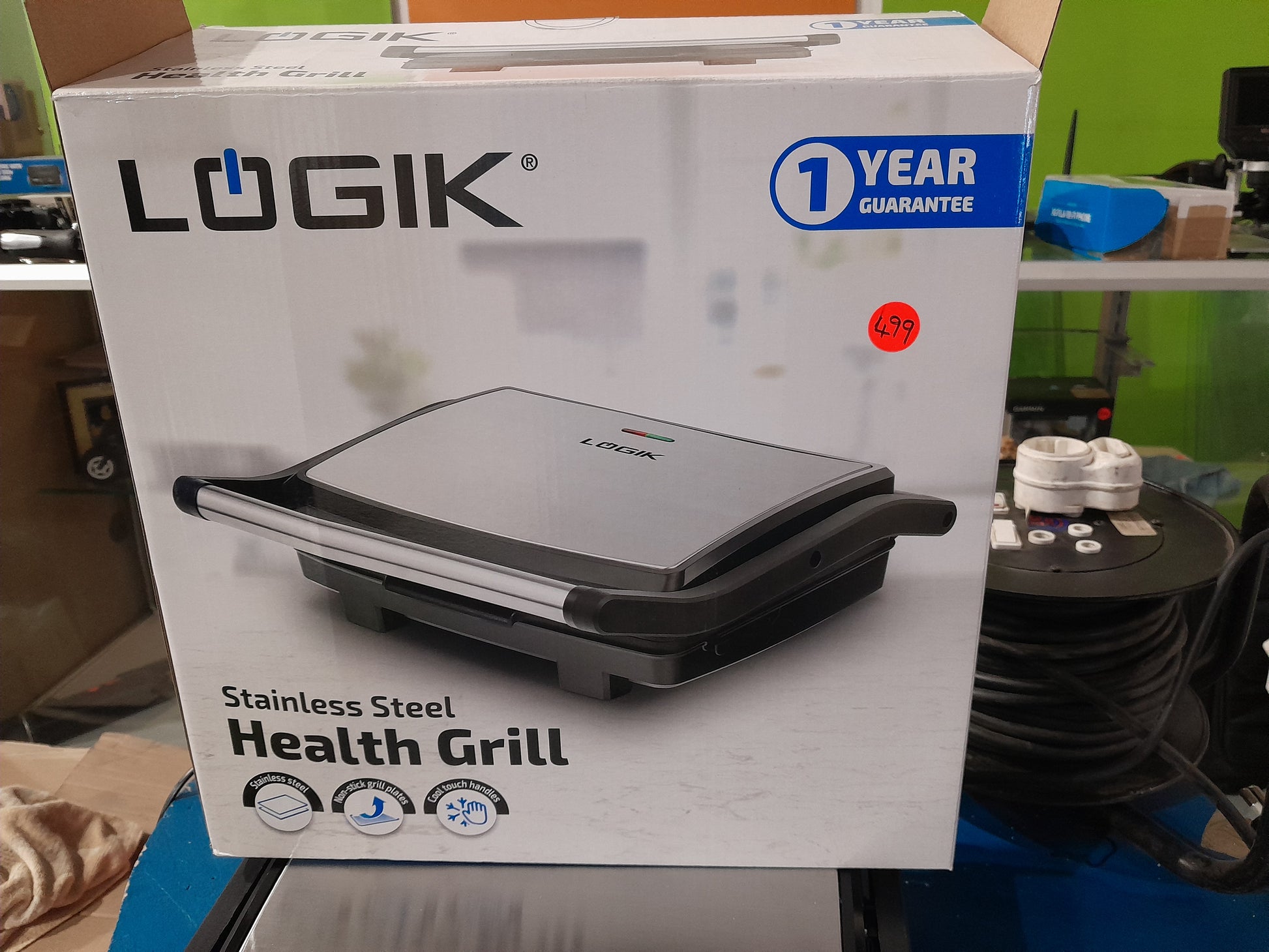 Close-up of Logik Health Grill label highlighting its 1-year guarantee and features.