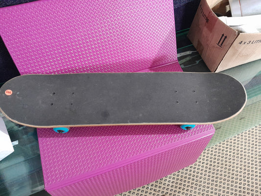 Top view of a used Kerb skateboard with a wooden deck and blue wheels, ideal for recreation.