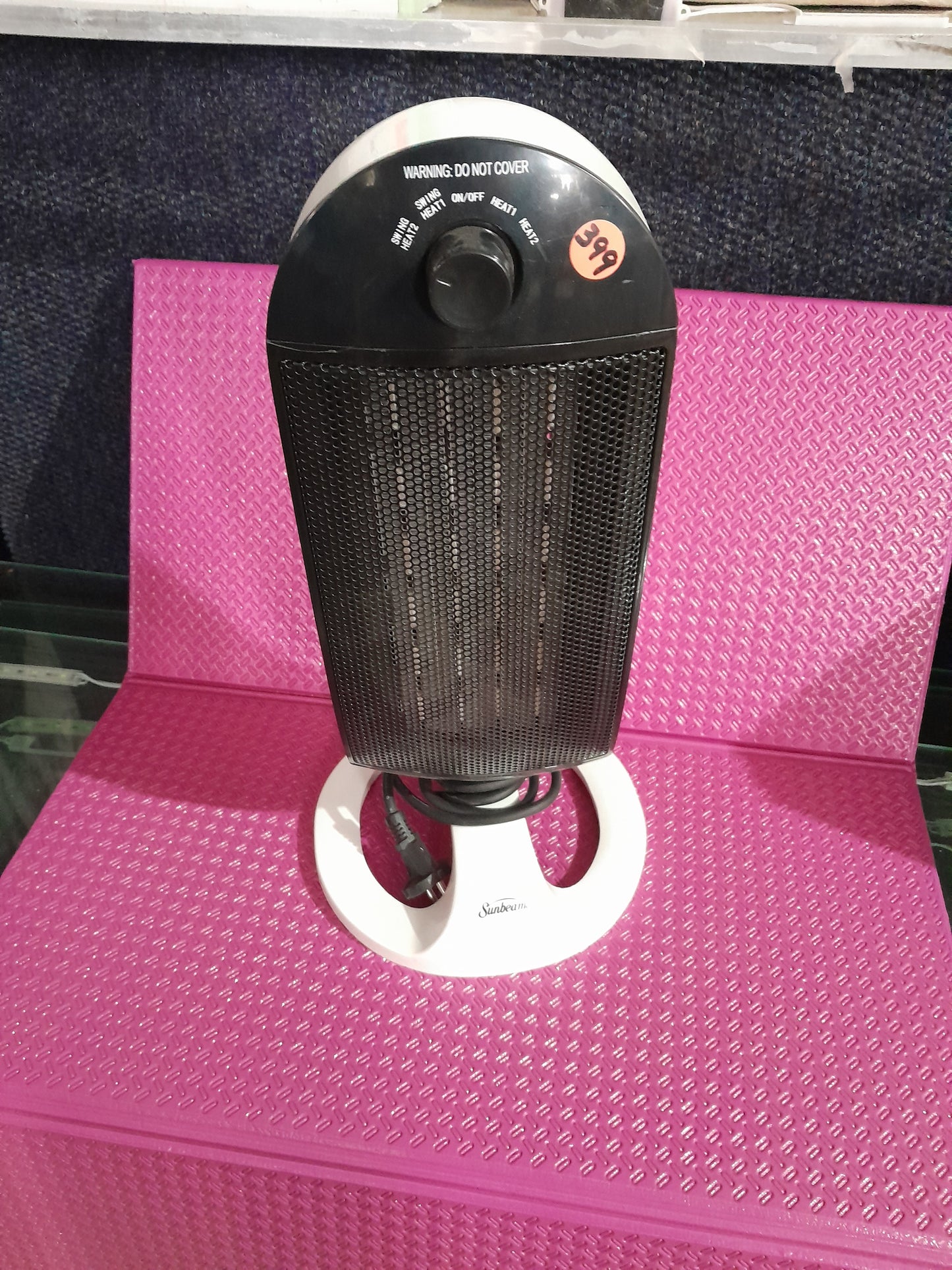 Sunbeam PTC oscillating table heater with adjustable settings for efficient heating.