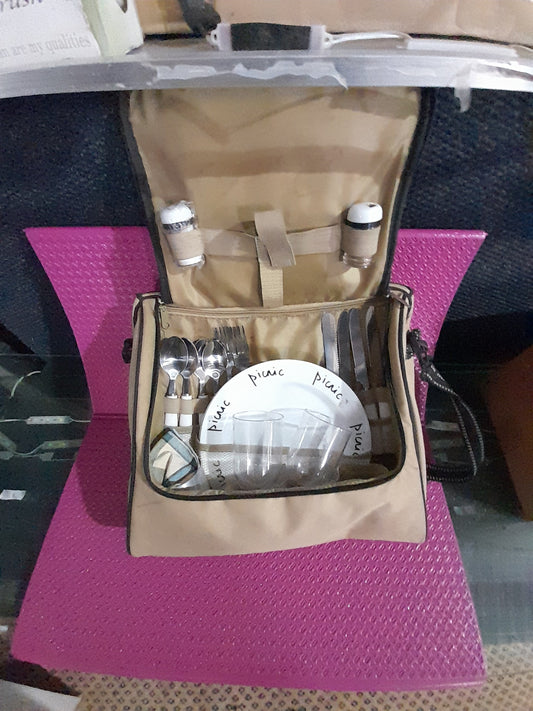 Outdoor picnic set complete with utensils, plates, and condiments, all packed in a stylish bag.