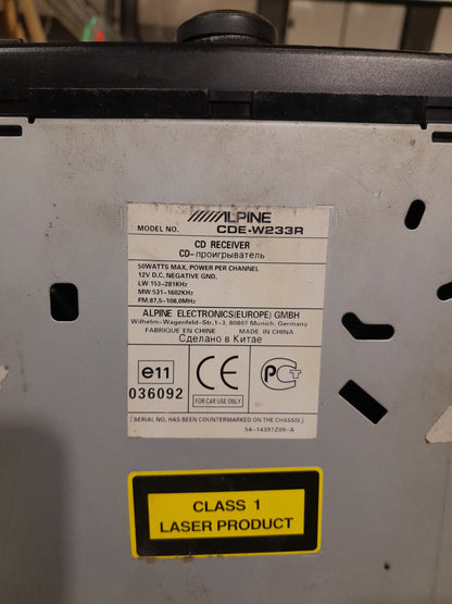 Product information label of Alpine CDE-W233R 2-DIN car receiver with power ratings.
