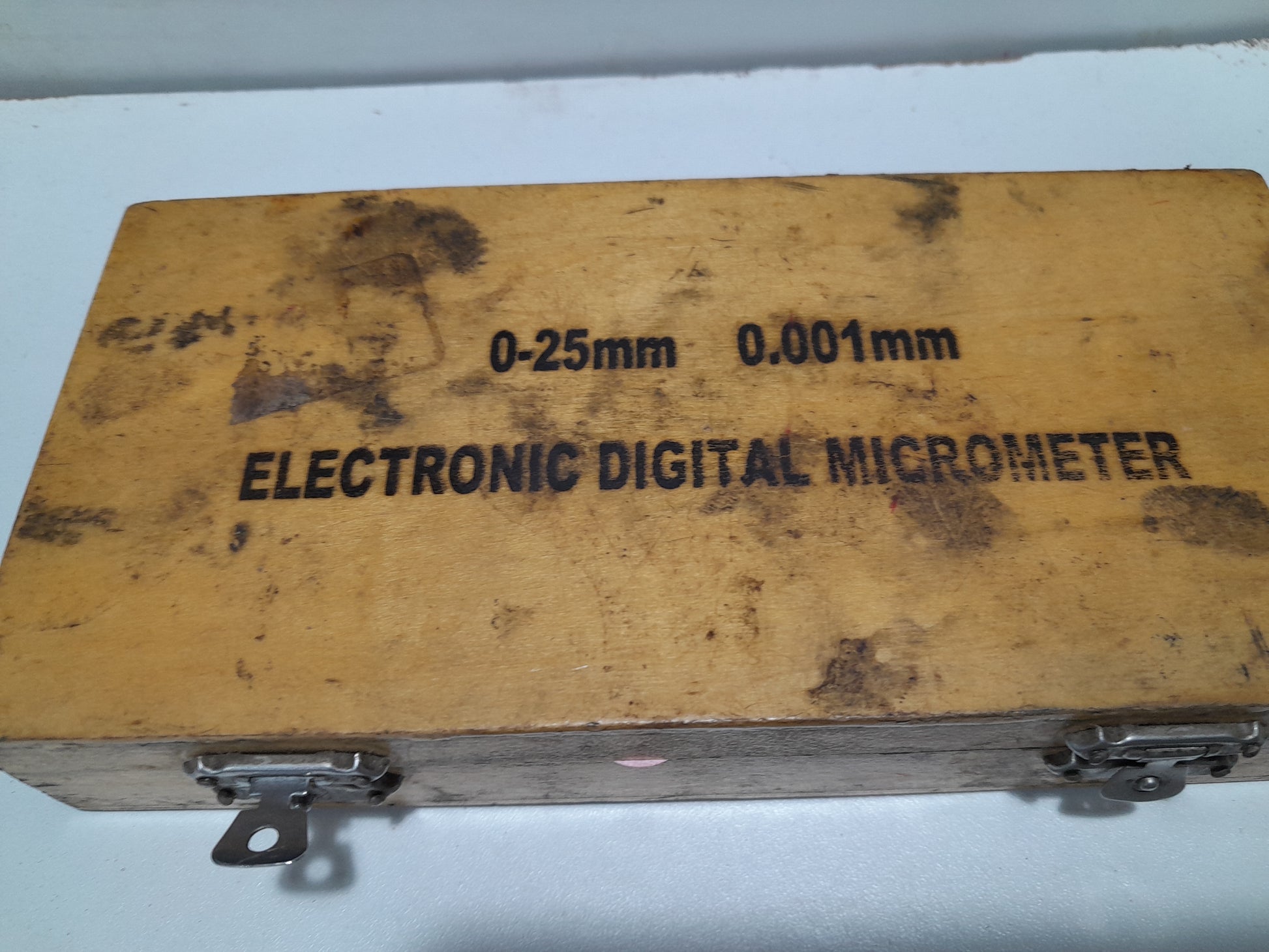 Close-up of an electronic digital micrometer, showcasing its detailed display and precision features.