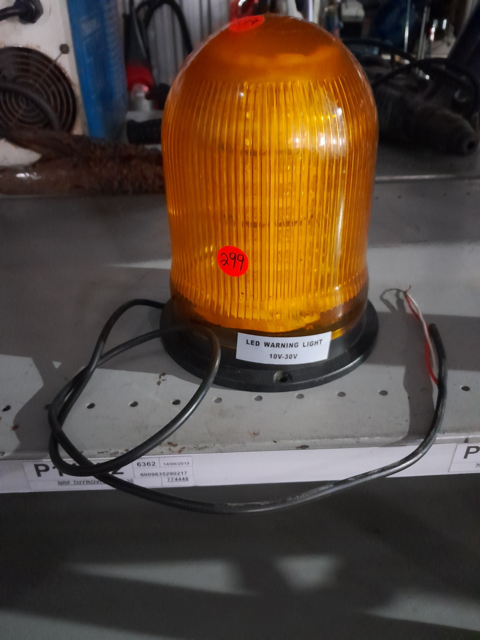 High-visibility orange LED warning light, commonly used in emergency and safety applications.