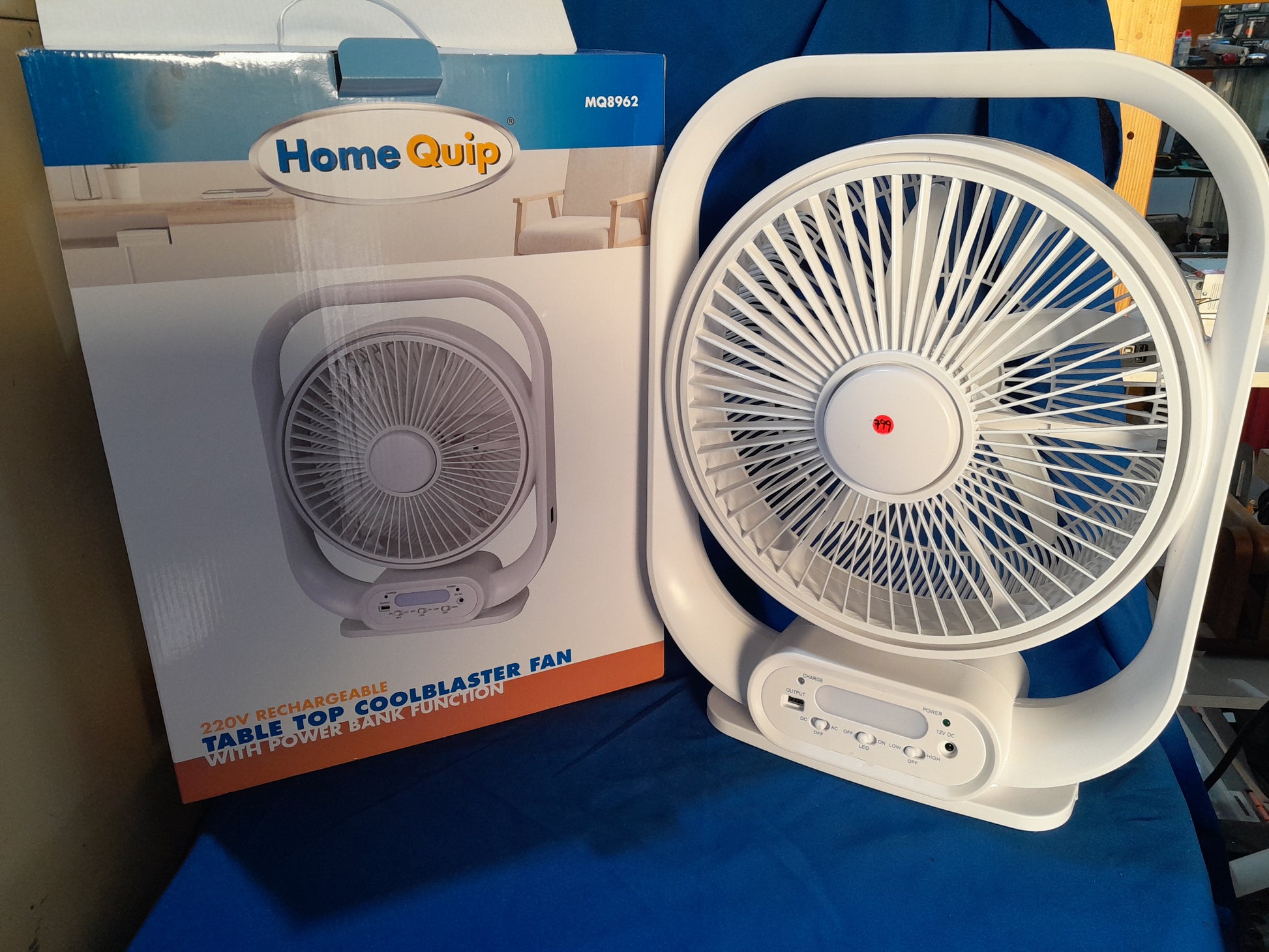 HomeQuip rechargeable fan packaging showcasing its tabletop design and power bank capability.