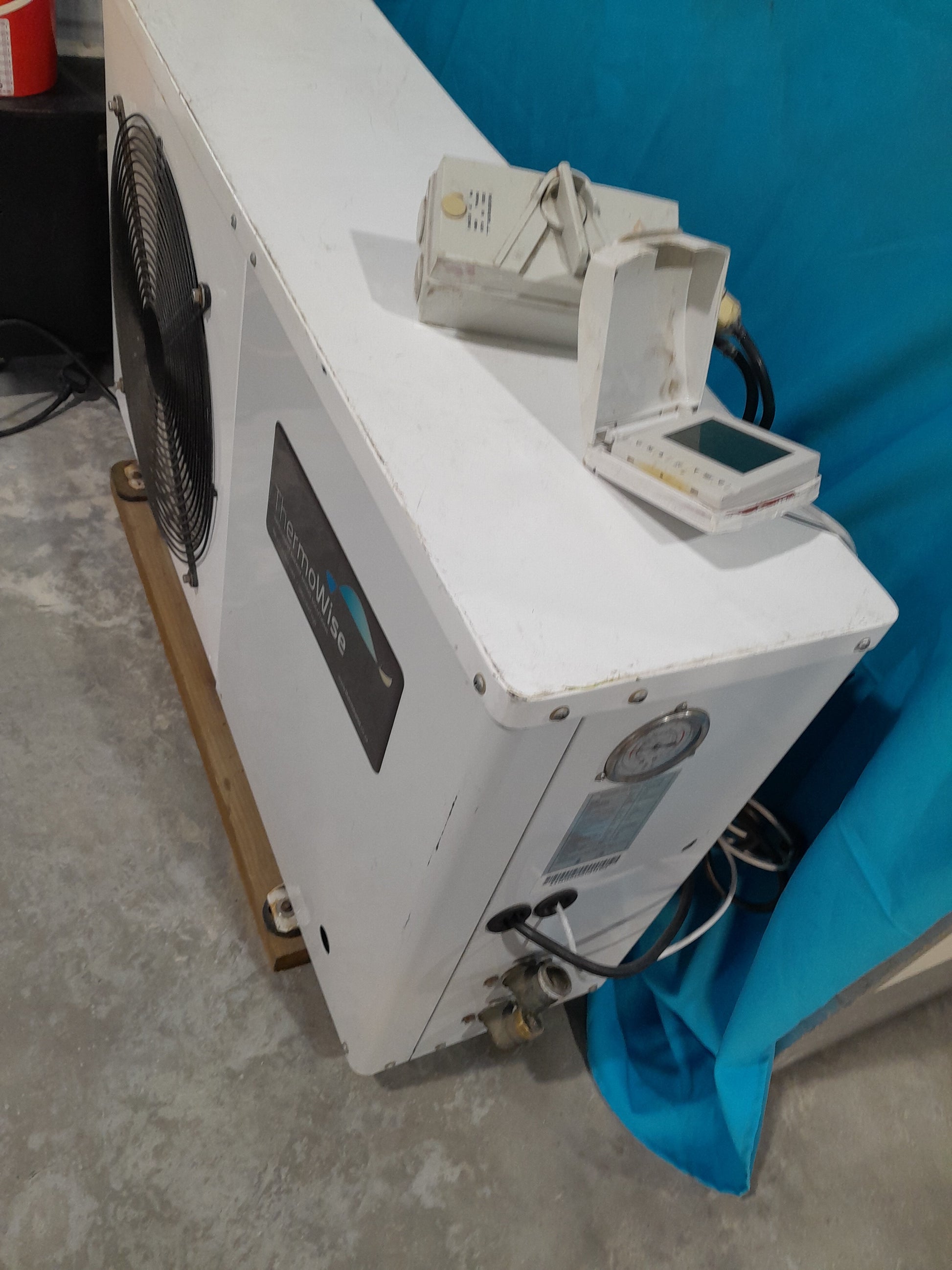 ThermoWise hot water heat pump unit with a large fan and control panel, ideal for energy-efficient water heating systems.