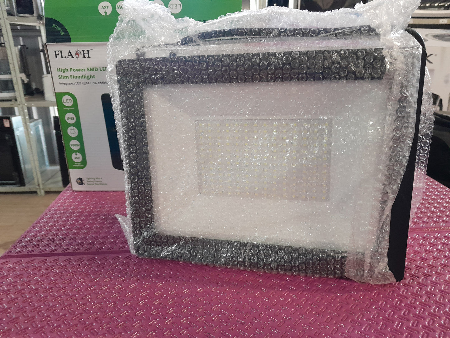 Flash High Power LED Floodlight displayed in store, showcasing its modern design and specifications.