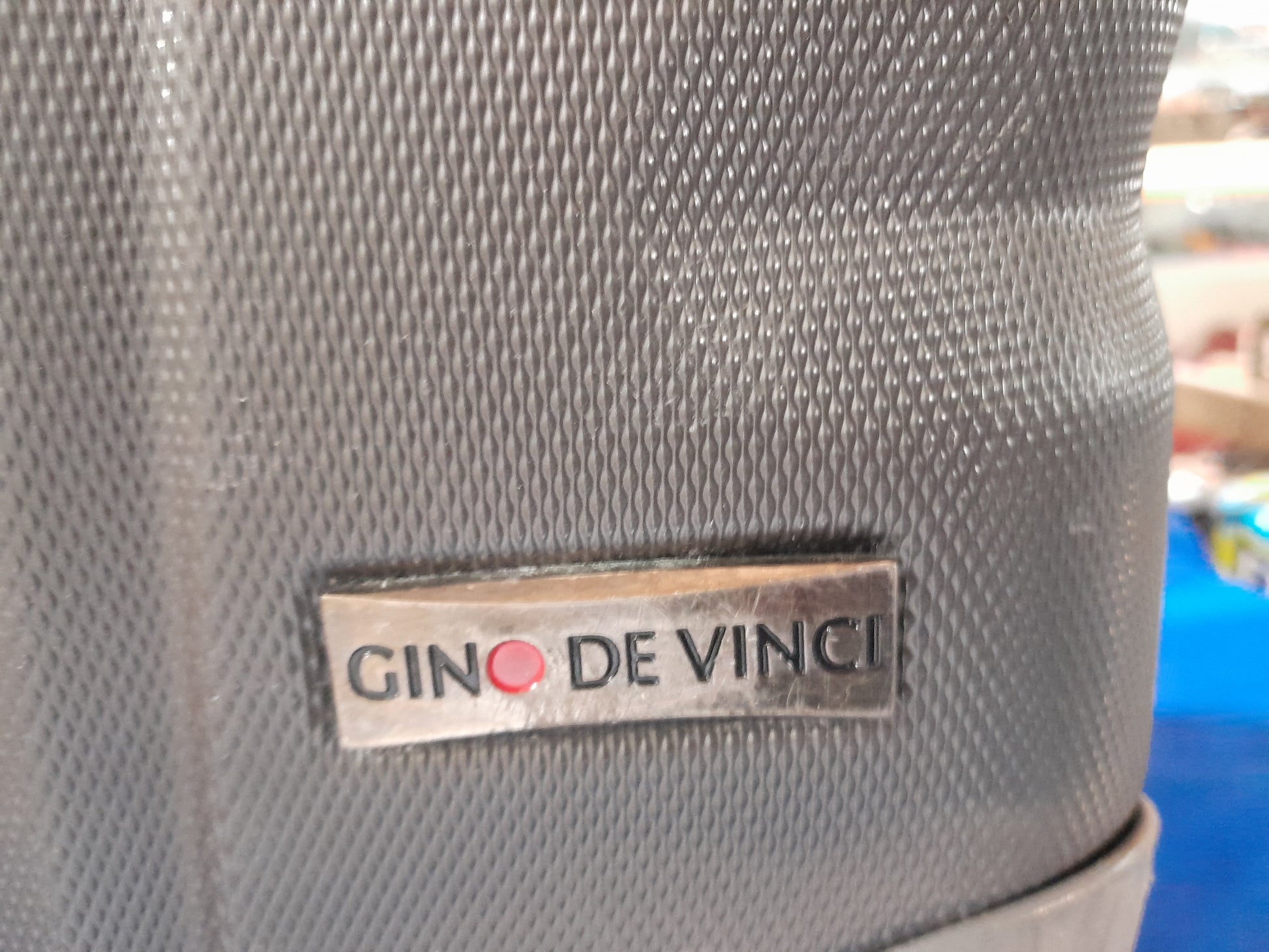 Gino De Vince Cabin Trolley Case displayed on a blue background, highlighting its travel-friendly features.