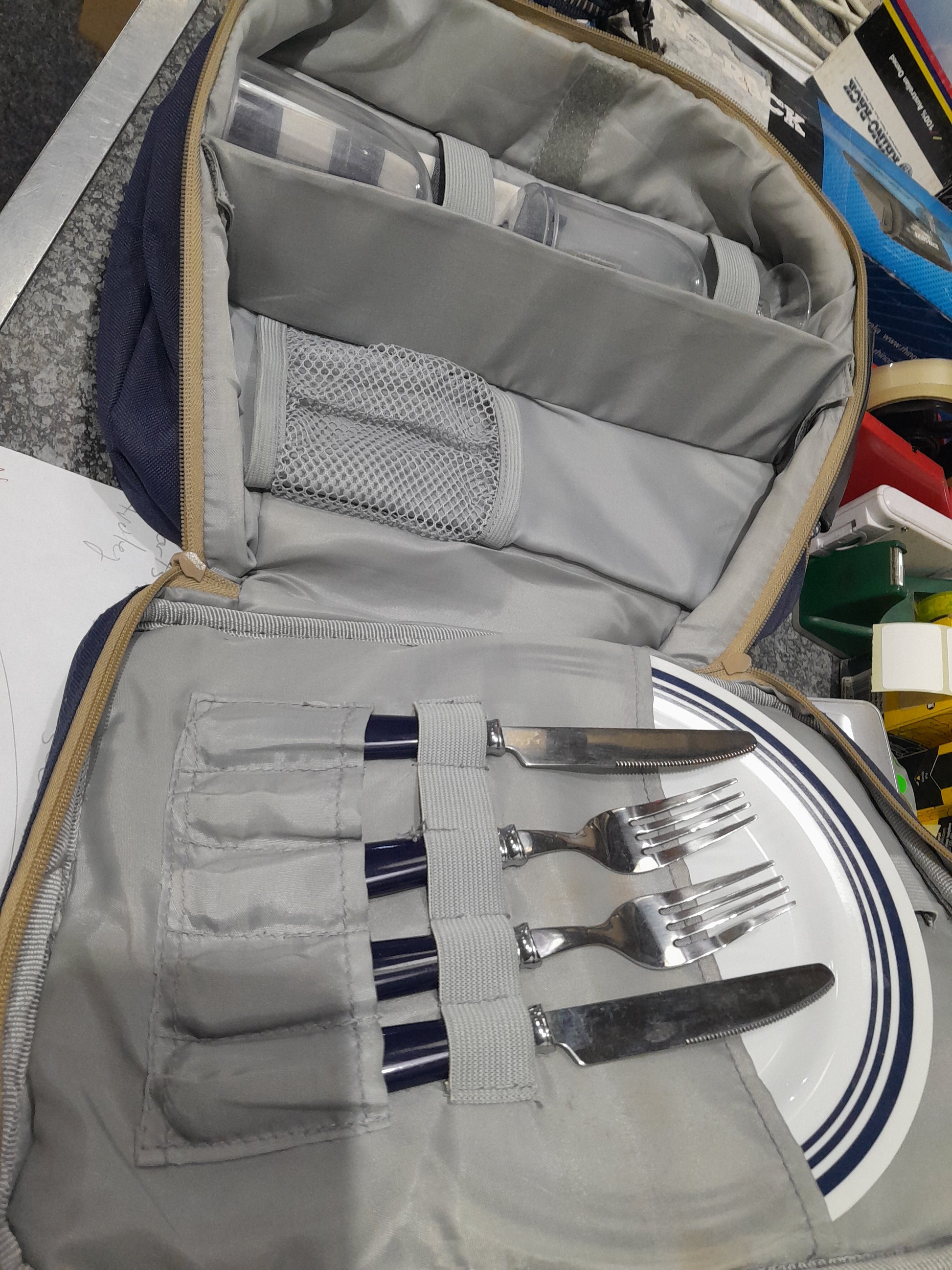 Portable picnic set for two, featuring plates, cutlery, and glasses in a stylish carry bag