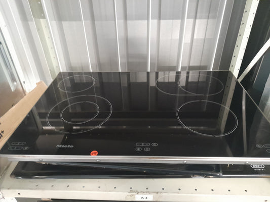 Miele KM5753 induction hob with four heating zones and sleek black ceramic glass surface.