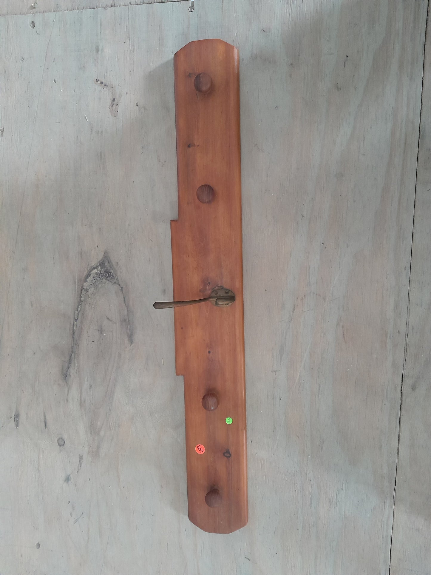 Solid wood Shaker peg rail for hanging coats and aprons, perfect for home organization.