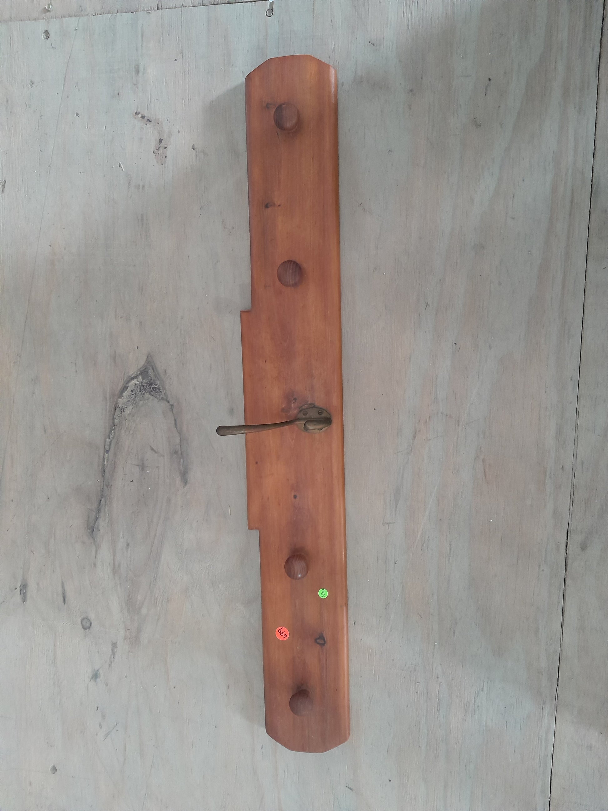 Solid wood Shaker peg rail for hanging coats and aprons, perfect for home organization.