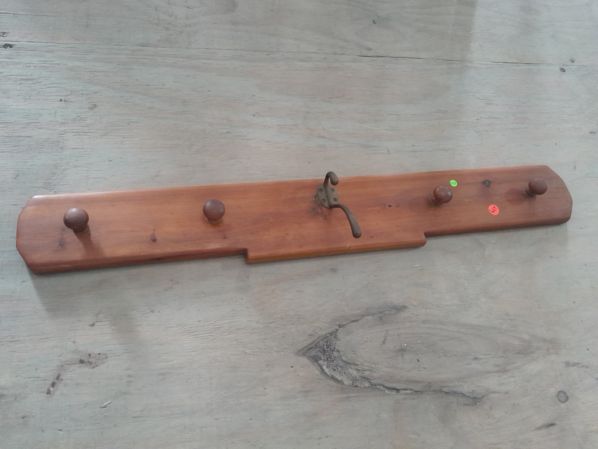 Vintage Shaker peg rail made from solid wood, ideal for coats and aprons in any entryway.