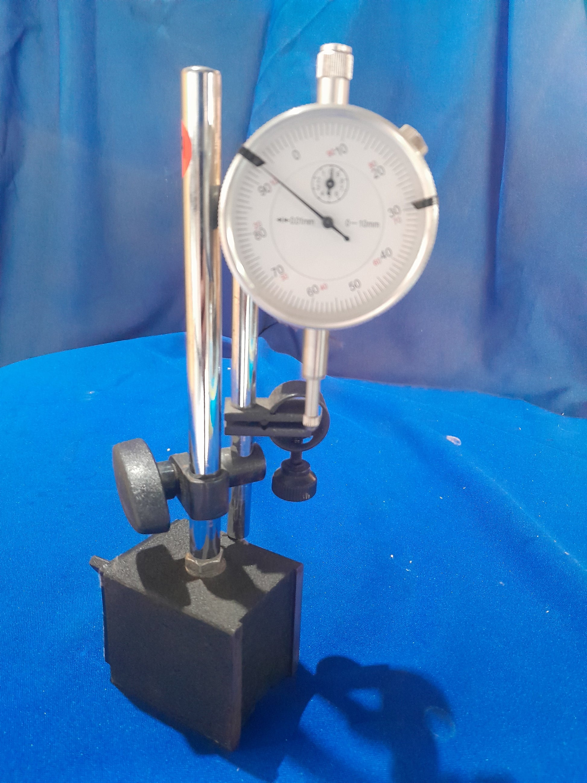 Close-up of a magnetic dial indicator gauge, showing a clear scale for accurate measurements up to 10mm.