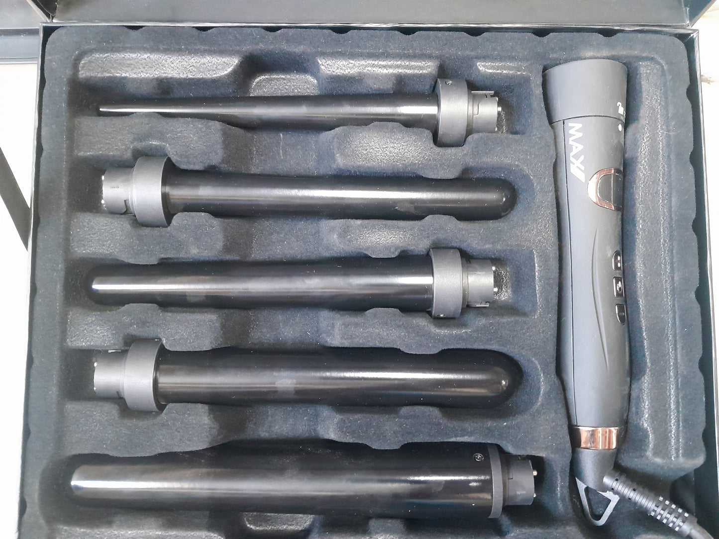 Open case showing Max Pro Miracle 5 in 1 Curling Tongs and interchangeable barrels for various curls.
