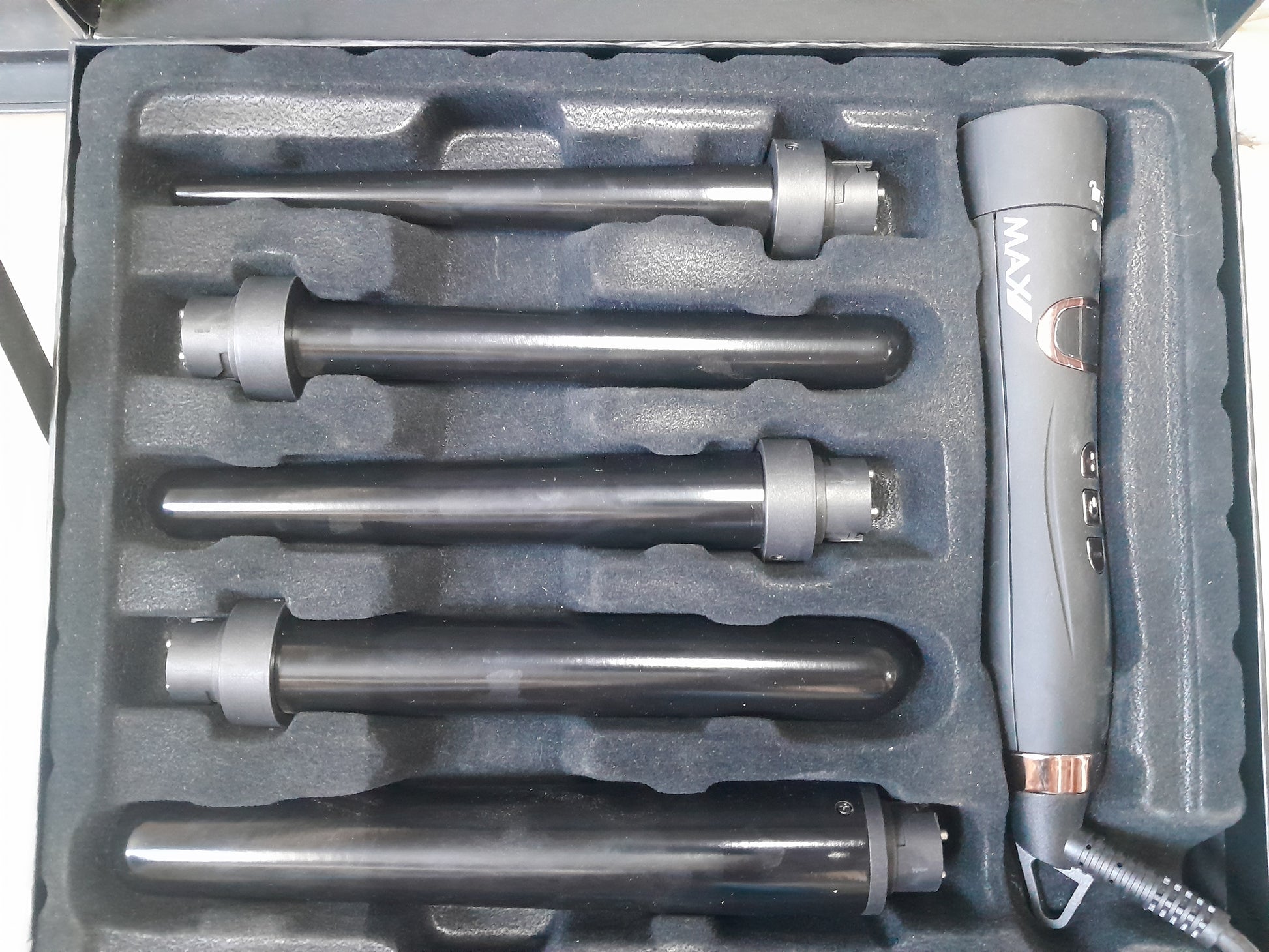 Open case showing Max Pro Miracle 5 in 1 Curling Tongs and interchangeable barrels for various curls.