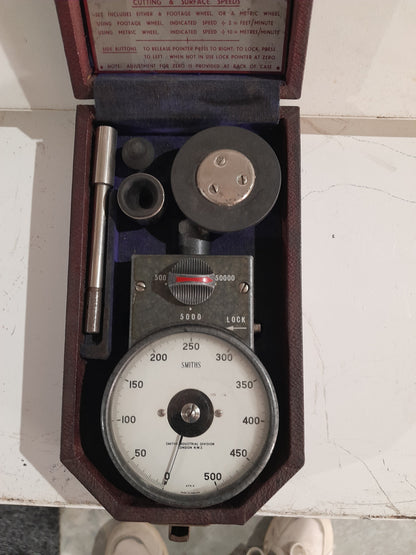 Vintage hand tachometer in its protective case, ideal for measuring machine speeds.