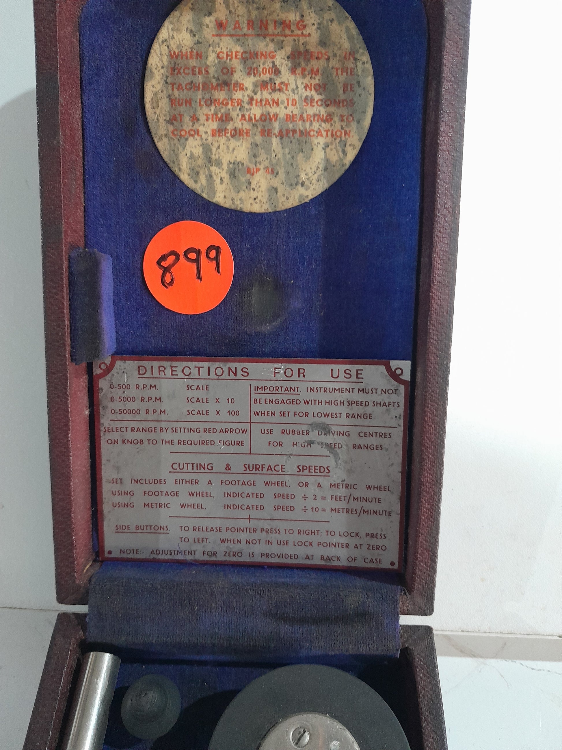Detailed view of vintage hand tachometer components, perfect for collectors and mechanics.