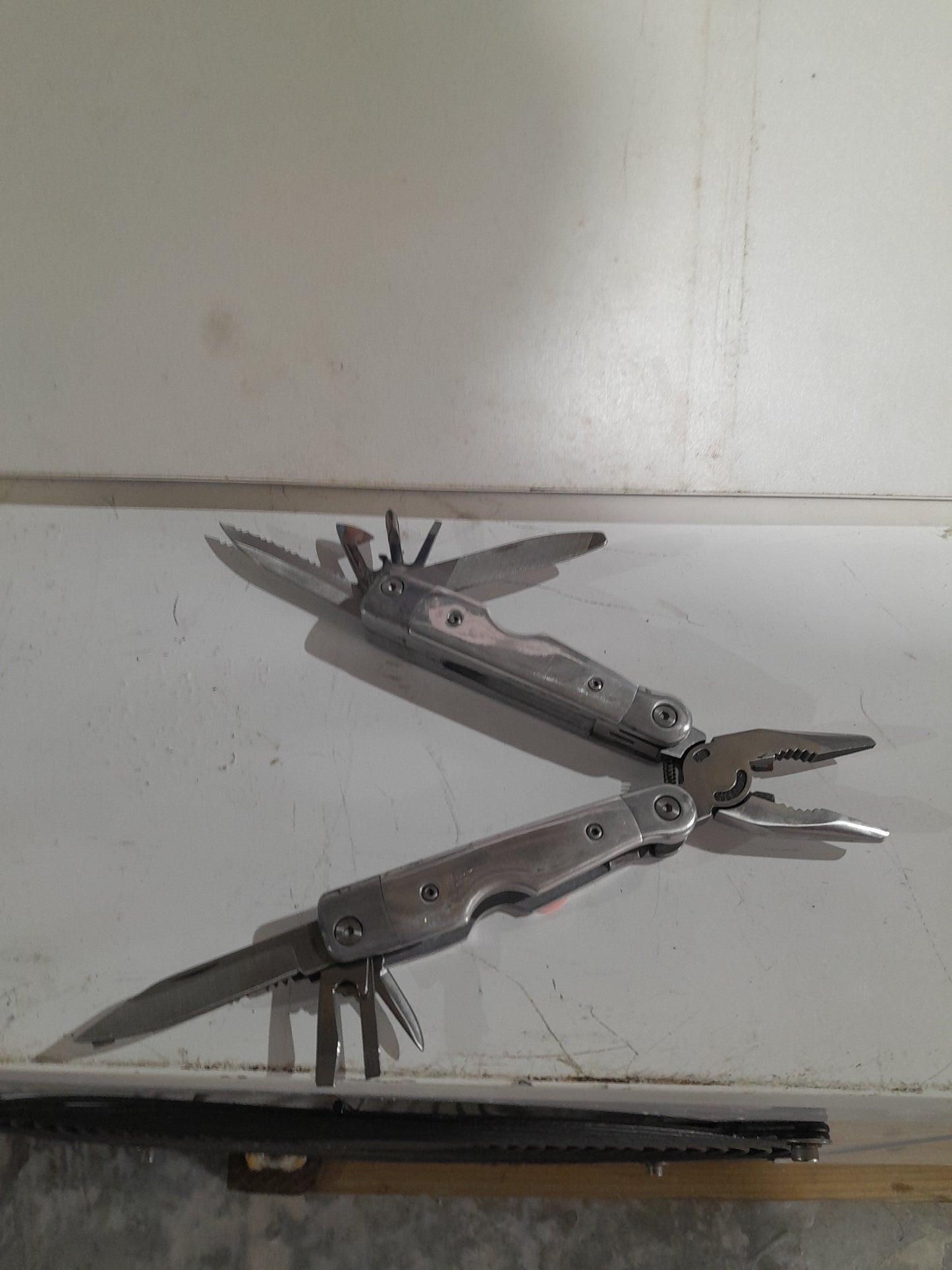 Multi-tool featuring multiple blades and tools, perfect for outdoor adventures and home repairs.