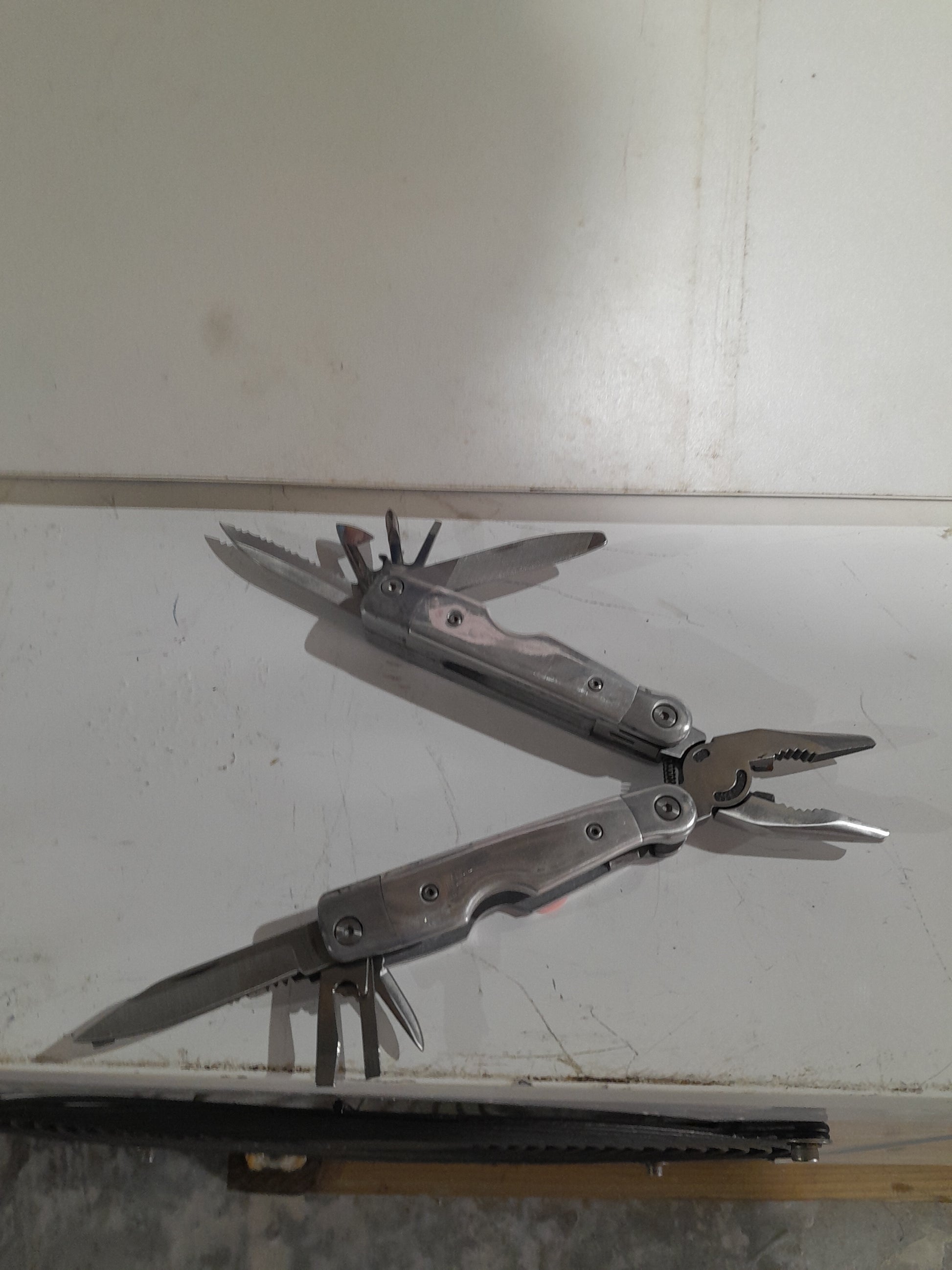 Multi-tool featuring multiple blades and tools, perfect for outdoor adventures and home repairs.