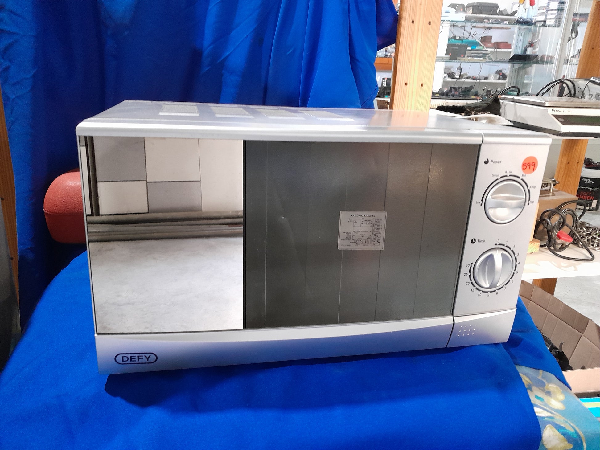 Silver Defy DMO 381 microwave with mirror glass door, ideal for modern kitchens, 700W power.