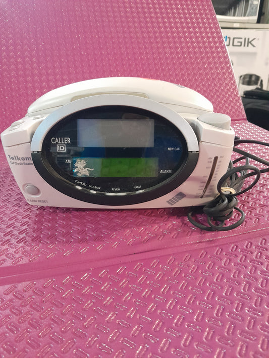 Close-up of Telkom clock radio phone highlighting its Caller ID and alarm settings.