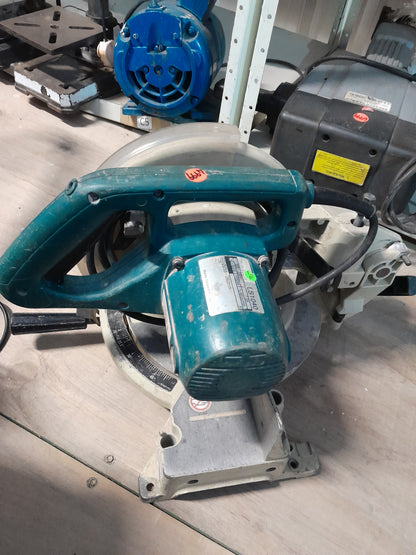 Makita LS1040 compound mitre saw positioned on a workbench, showcasing its sturdy design.