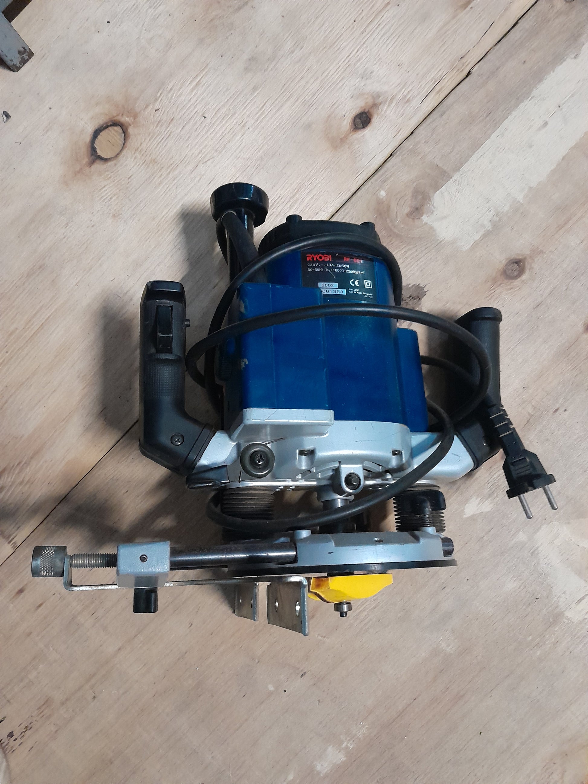 Ryobi Industrial Router positioned on wood surface, ideal for woodworking projects.