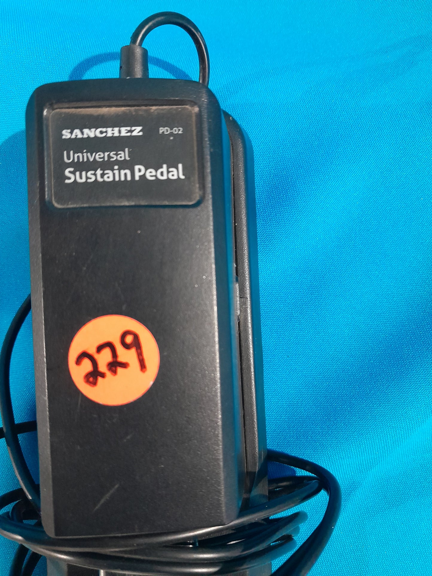 Detailed image of Sanchez Sustain Pedal with cable, essential for enhancing piano performance.