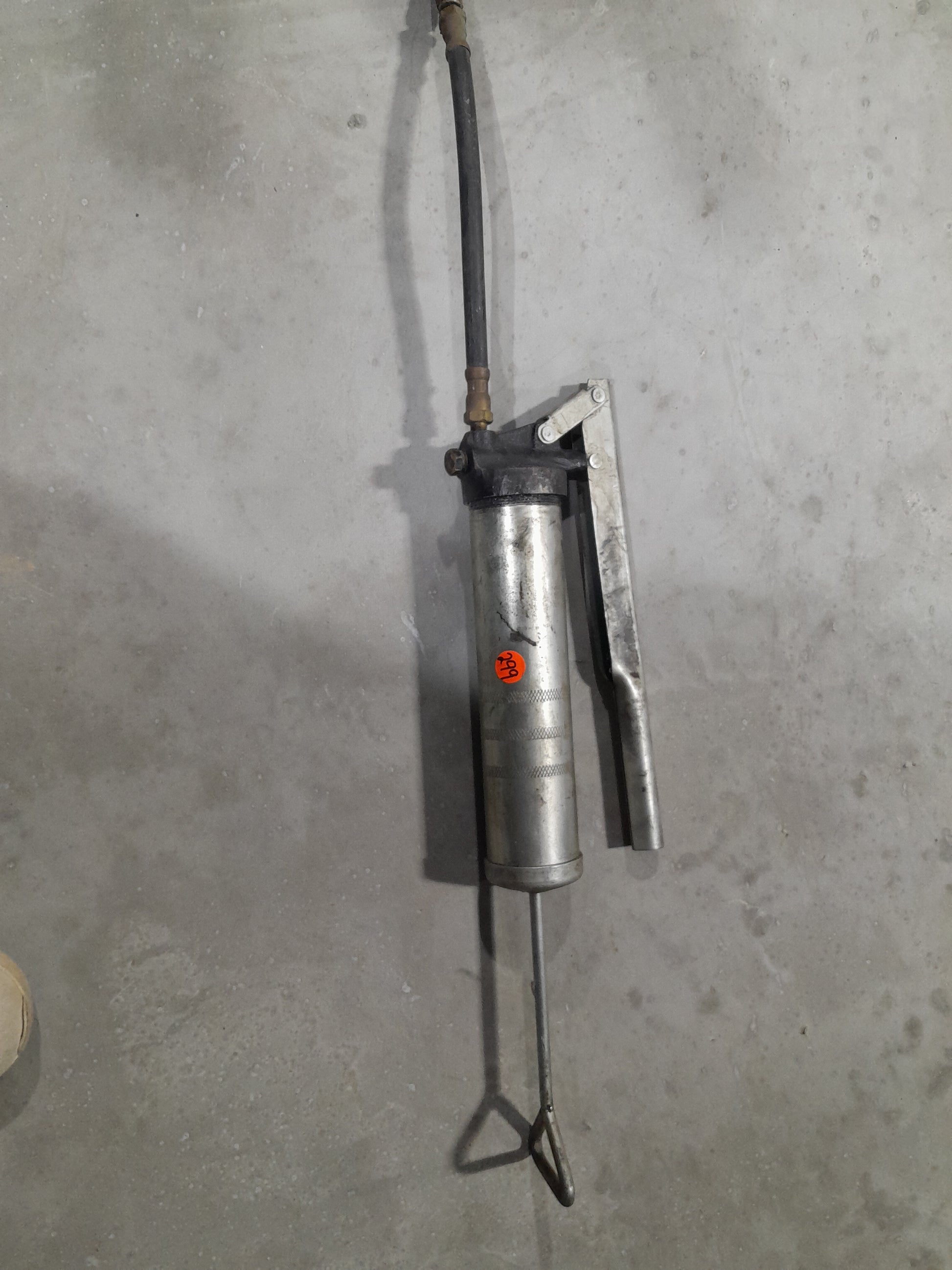 A lever action grease gun designed for general lubrication and maintenance tasks.