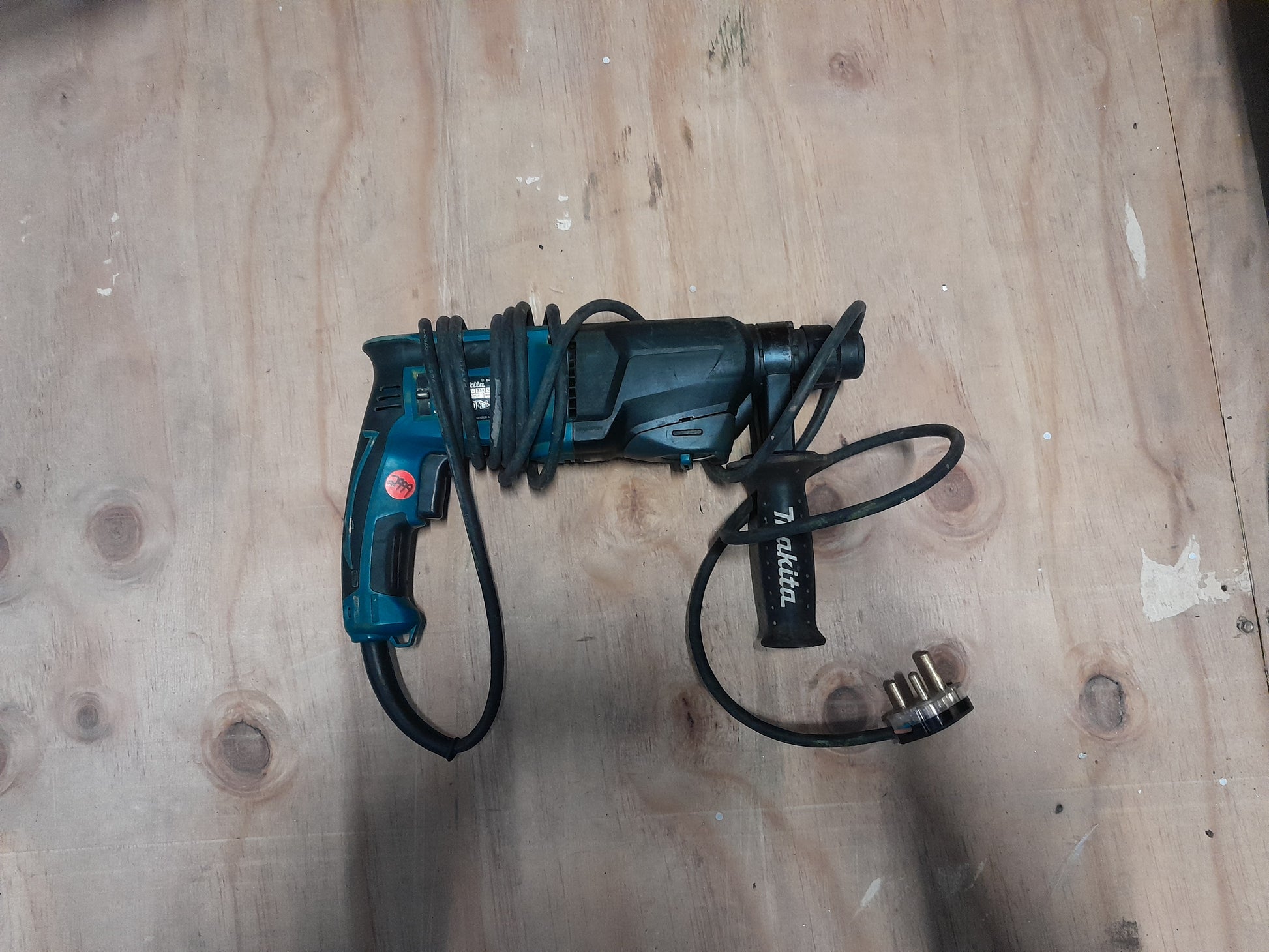 Makita HR2600 rotary hammer drill with one-touch chuck for easy bit changes.