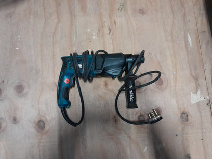 Makita HR2600 rotary hammer drill with one-touch chuck for easy bit changes.