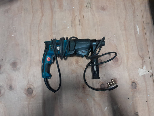 Makita HR2600 rotary hammer drill with one-touch chuck for easy bit changes.